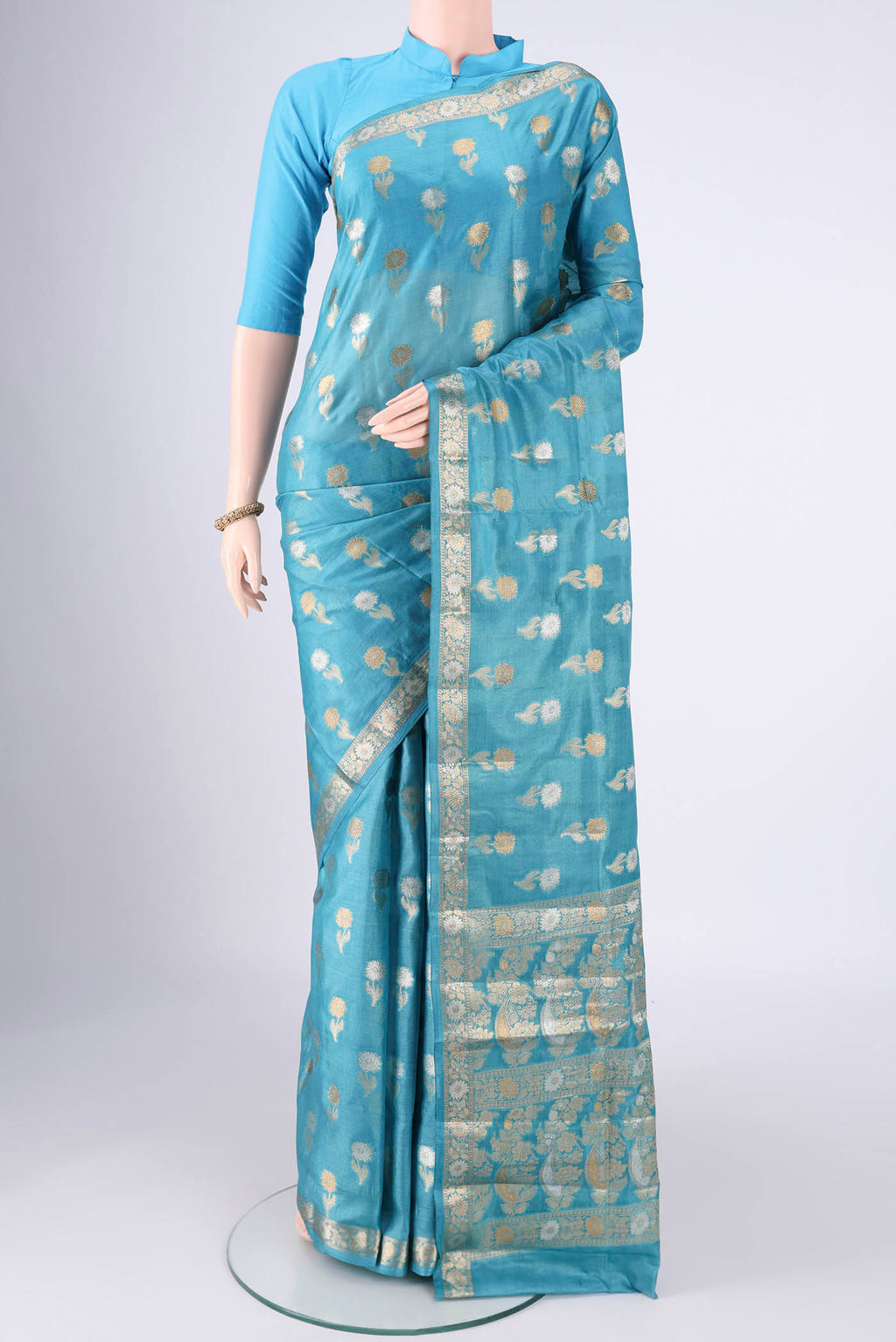 Blue Banarasi Tussar Silk Saree with Zari Butta on the body and Zari Border.  displayed on a mannequin