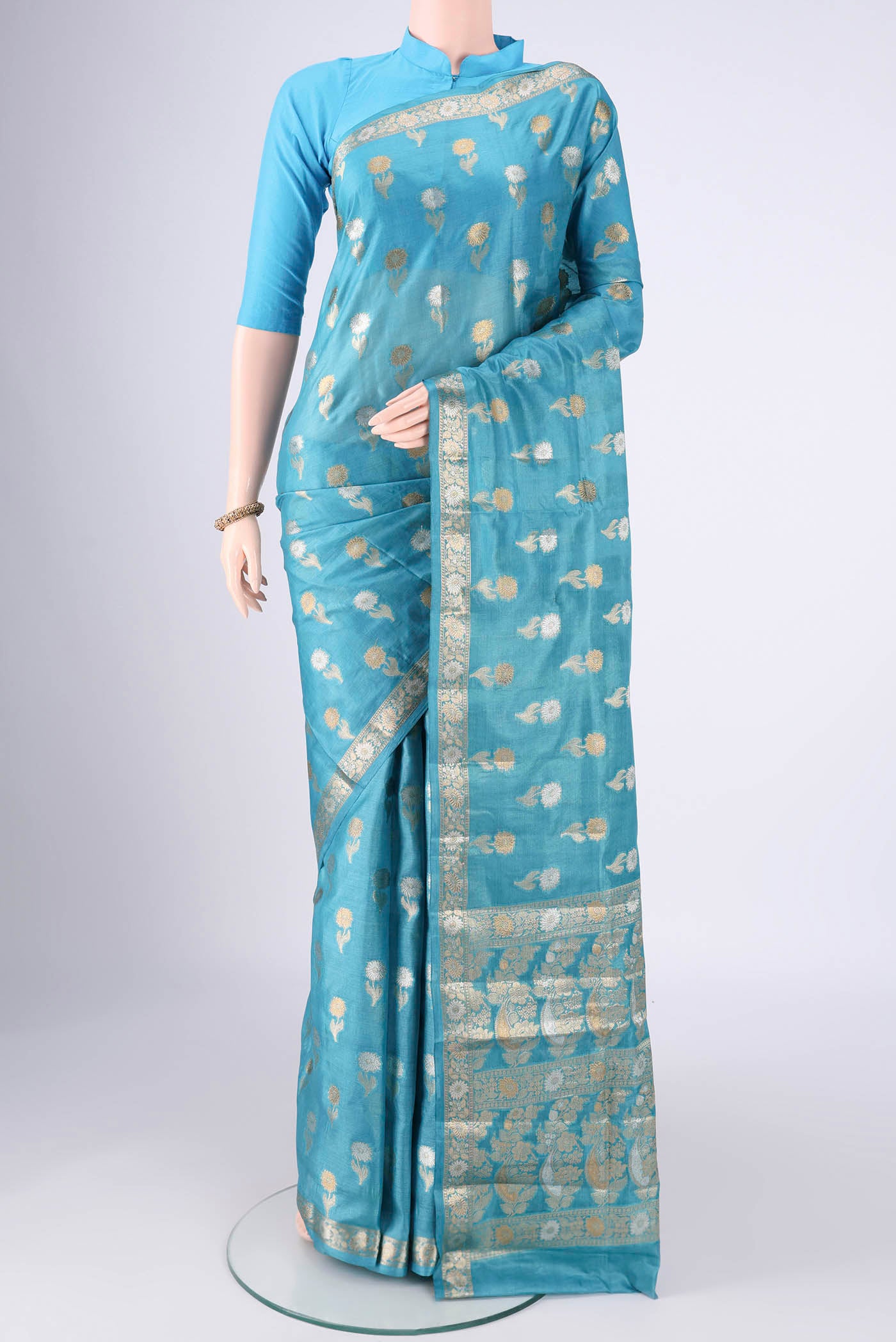 Blue Banarasi Tussar Silk Saree with Zari Butta on the body and Zari Border.  displayed on a mannequin