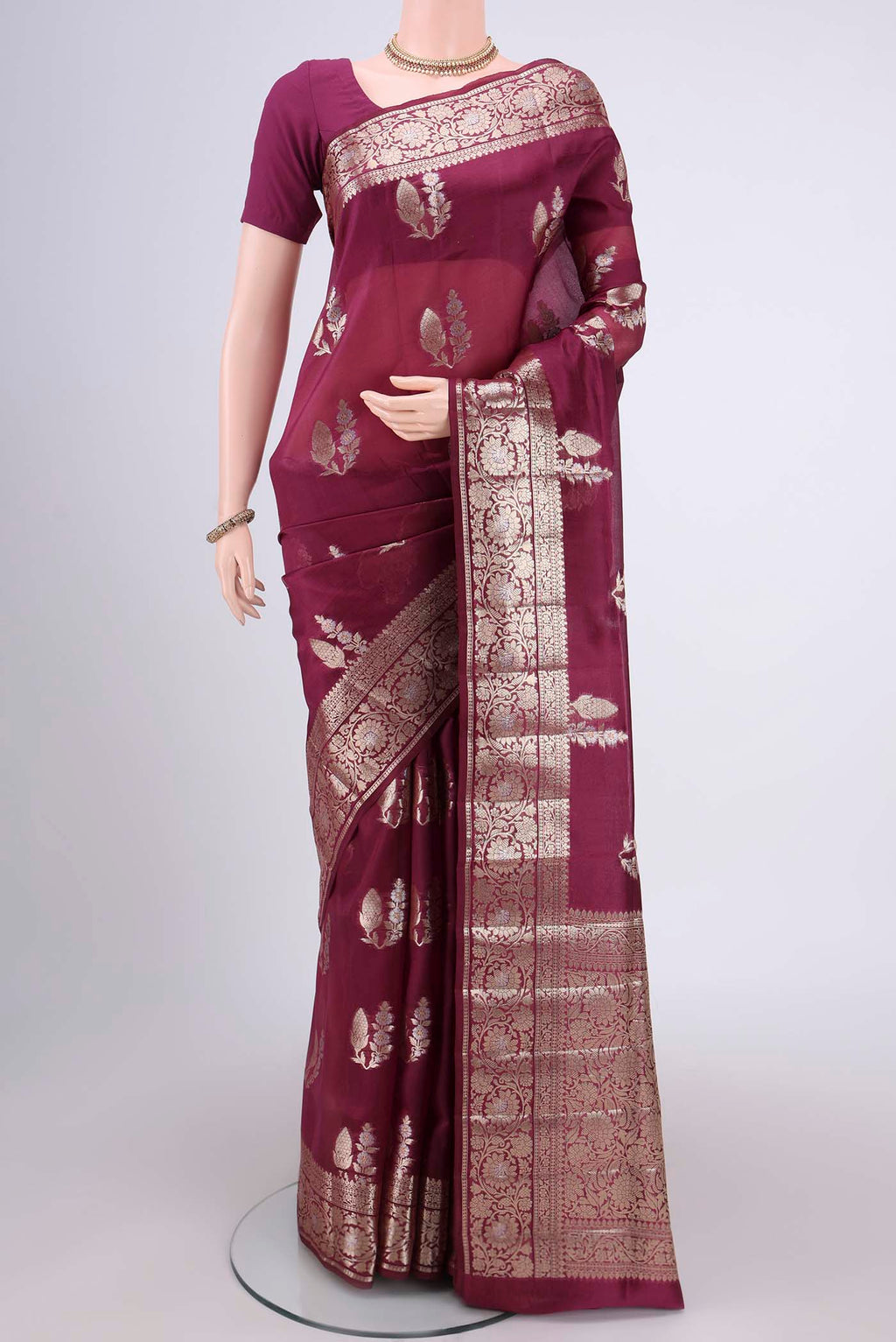 Magenta Banarasi Raw Silk Saree with Zari Butta on the body and Zari Border.  displayed on a mannequin