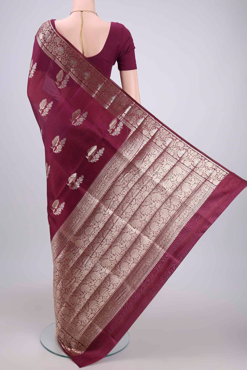 Flat view of Magenta Banarasi Raw Silk Saree with Zari Butta on the body and Zari Border. 