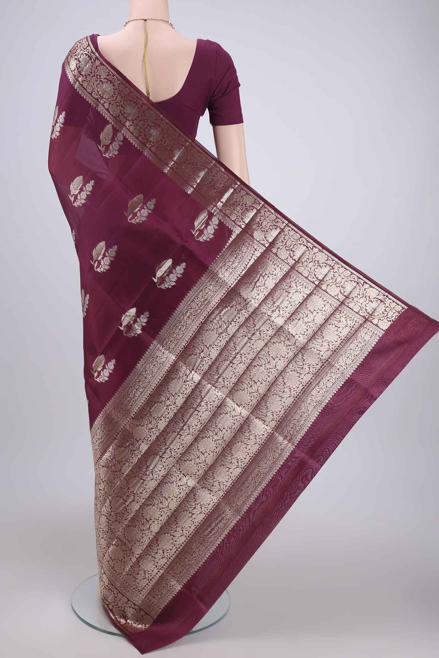 Flat view of Magenta Banarasi Raw Silk Saree with Zari Butta on the body and Zari Border. 