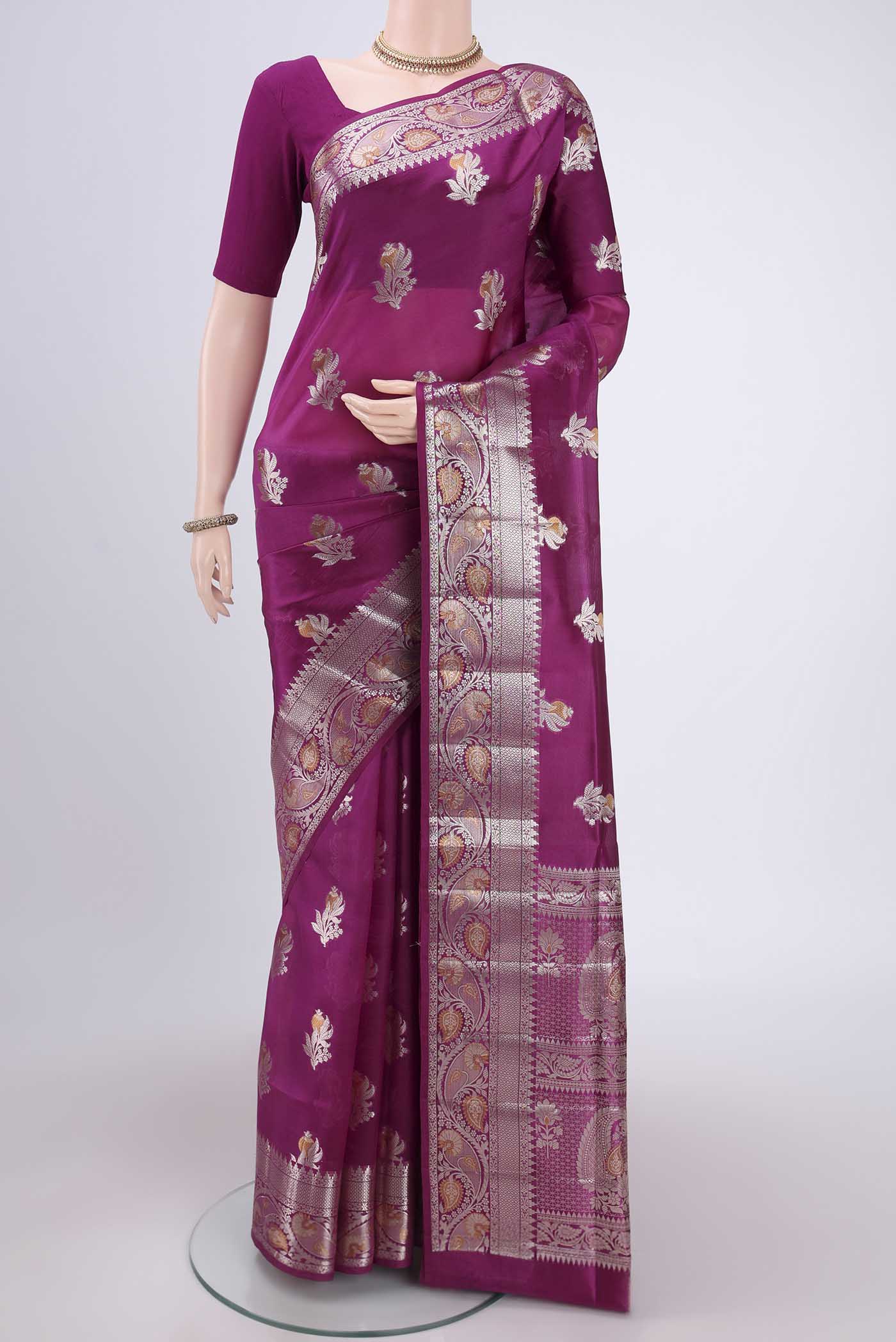 Magenta Banarasi Raw Silk Saree with Zari Butta on the body and Zari Border.  displayed on a mannequin