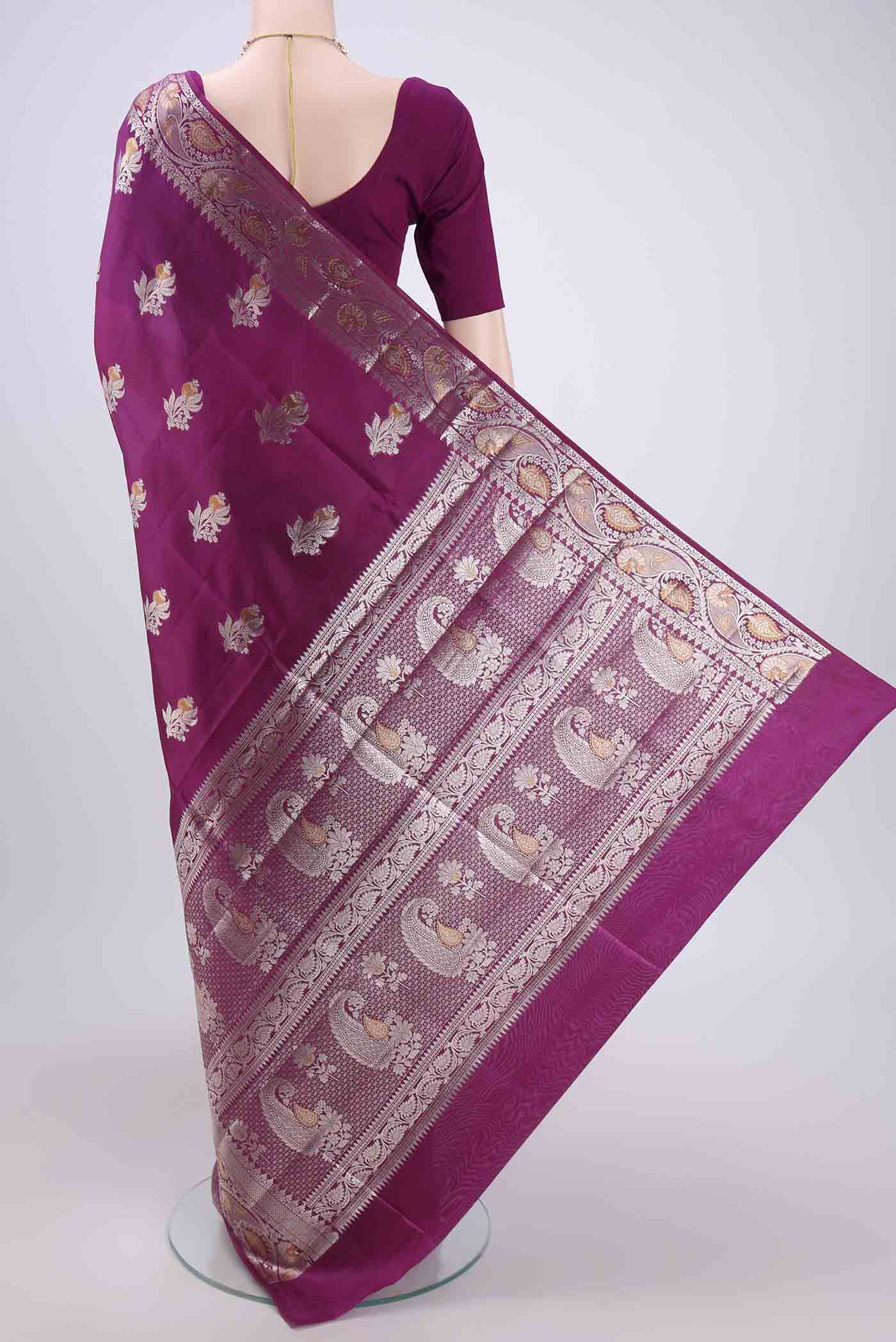 Flat view of Magenta Banarasi Raw Silk Saree with Zari Butta on the body and Zari Border. 
