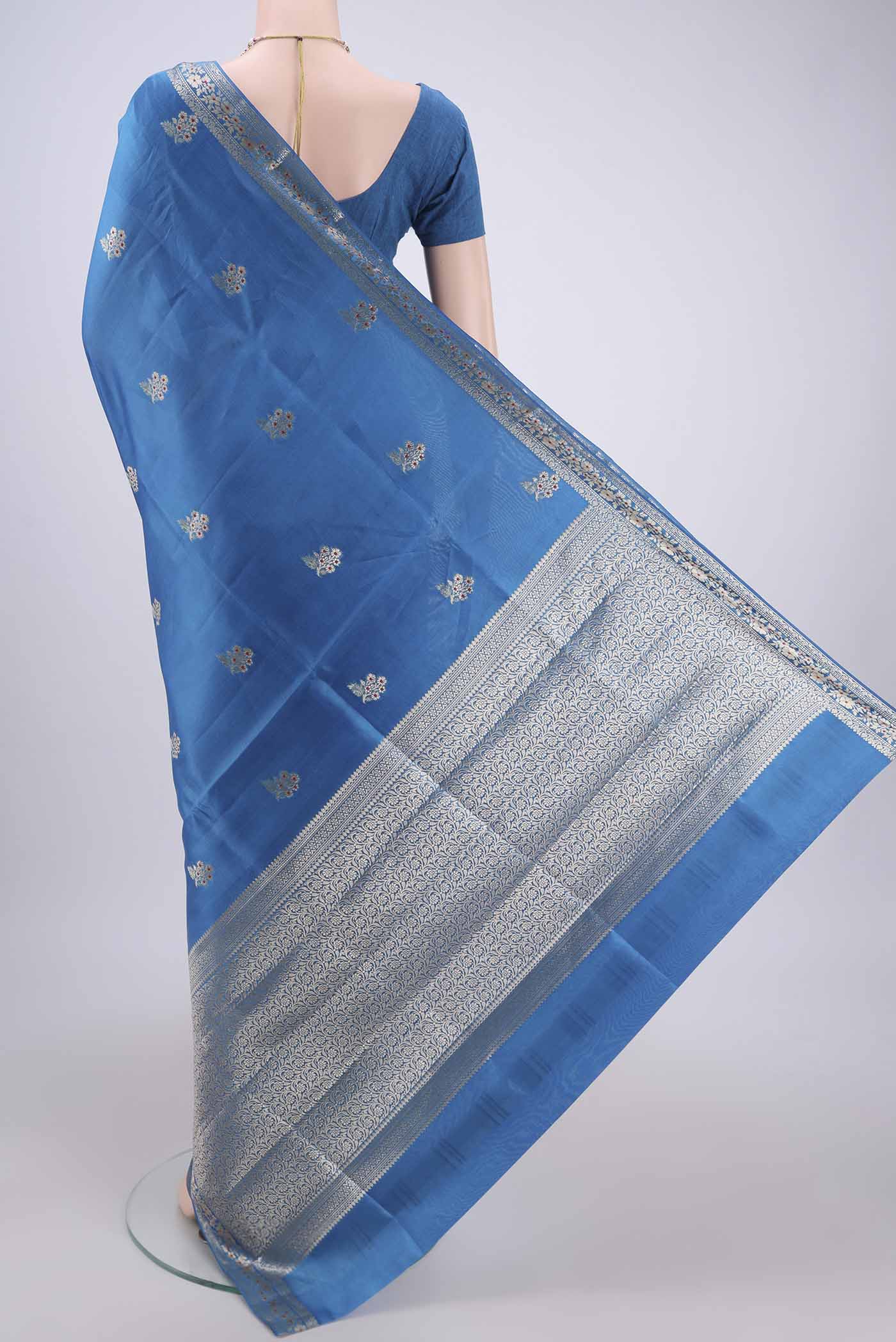 Flat view of Electric Blue Banarasi Raw Silk Saree with Zari And Thread Butta on the body and Zari And Thread Border. 