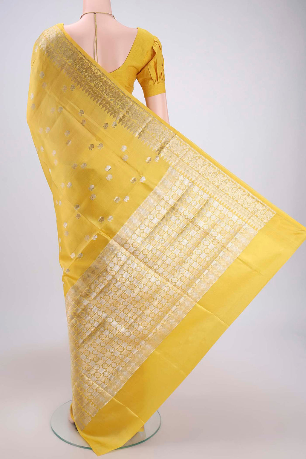 Flat view of Lemon Yellow Banarasi Raw Silk Saree with Zari Butta on the body and Zari Border. 