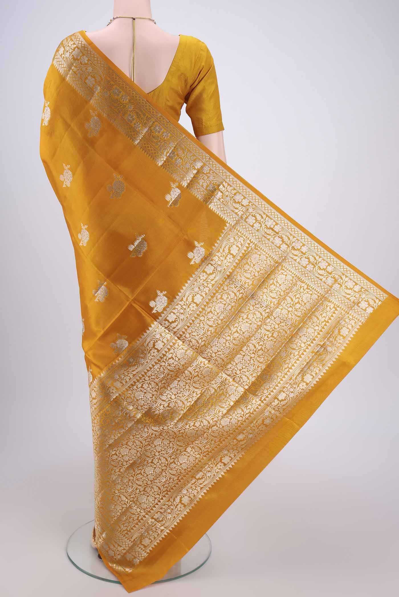 Flat view of Yellow Banarasi Raw Silk Saree with Zari Butta on the body and Zari Border. 