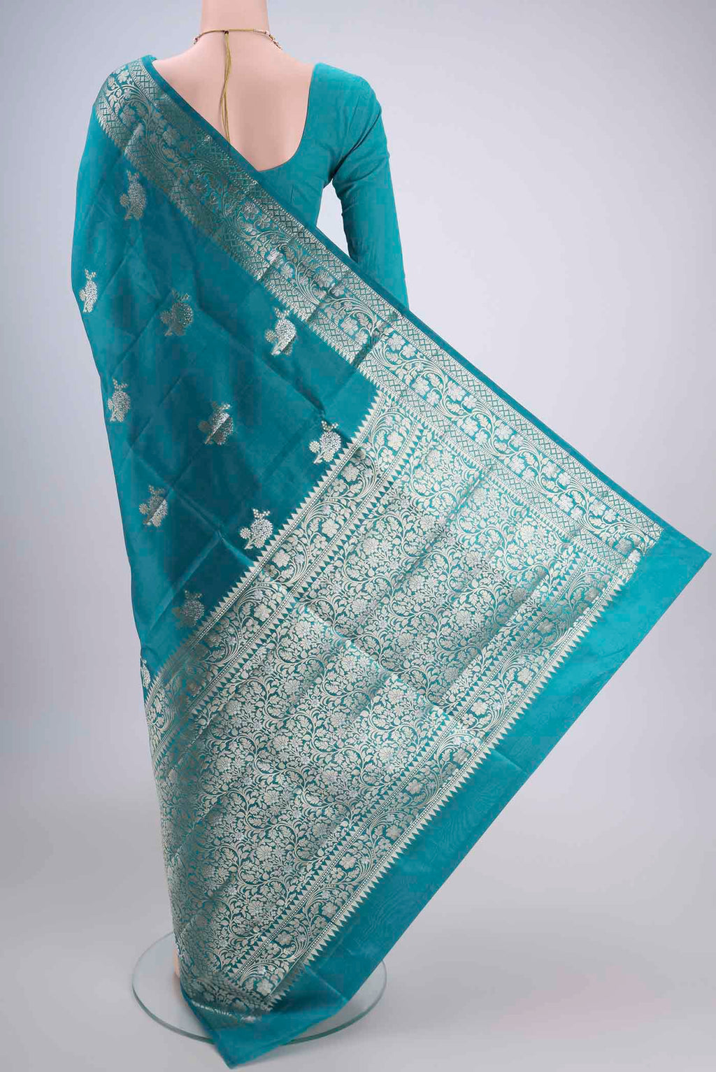 Flat view of Teal Banarasi Raw Silk Saree with Zari Butta on the body and Zari Border. 