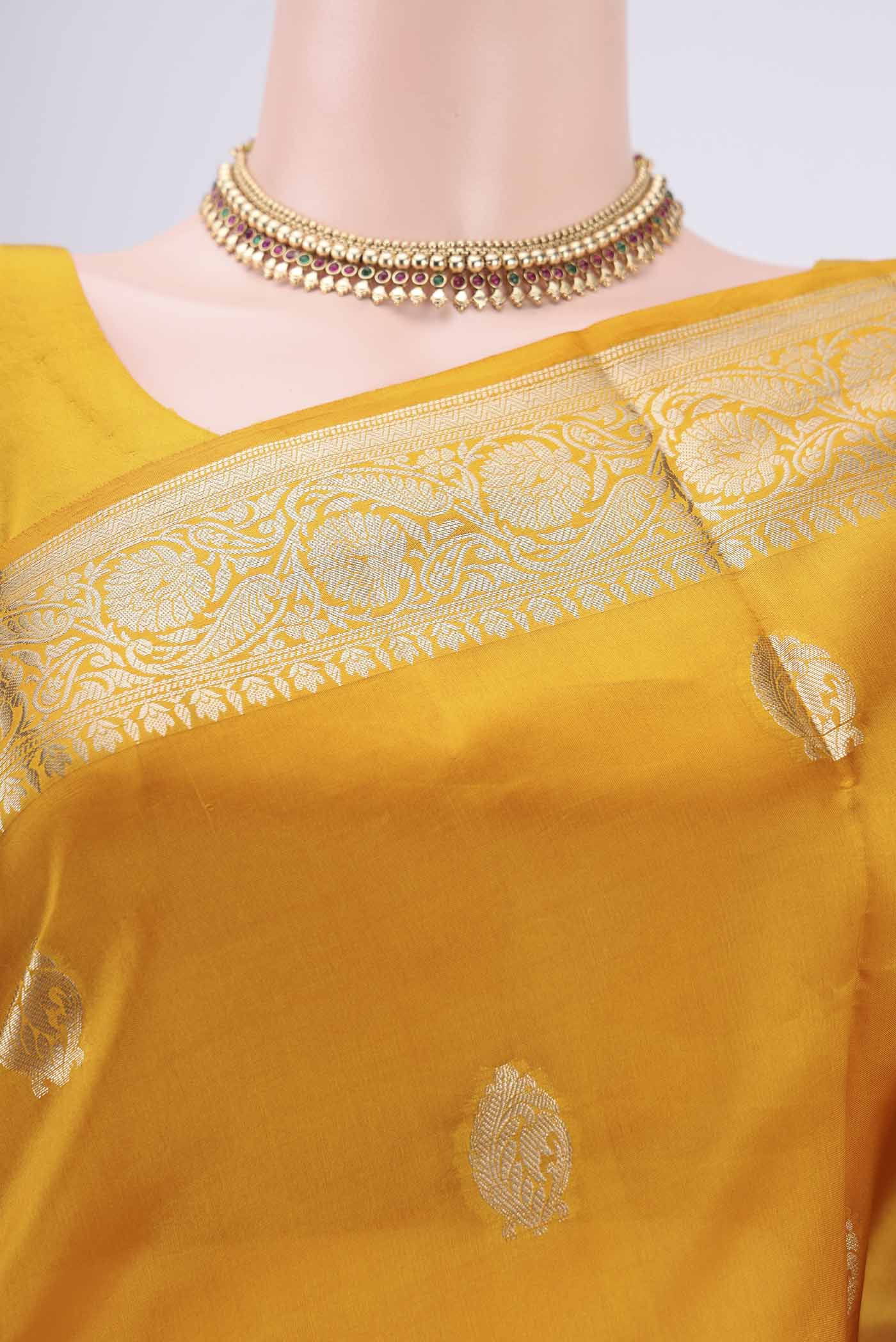 Border image of Yellow Banarasi Raw Silk Saree with Zari Butta on the body and Zari Border. 