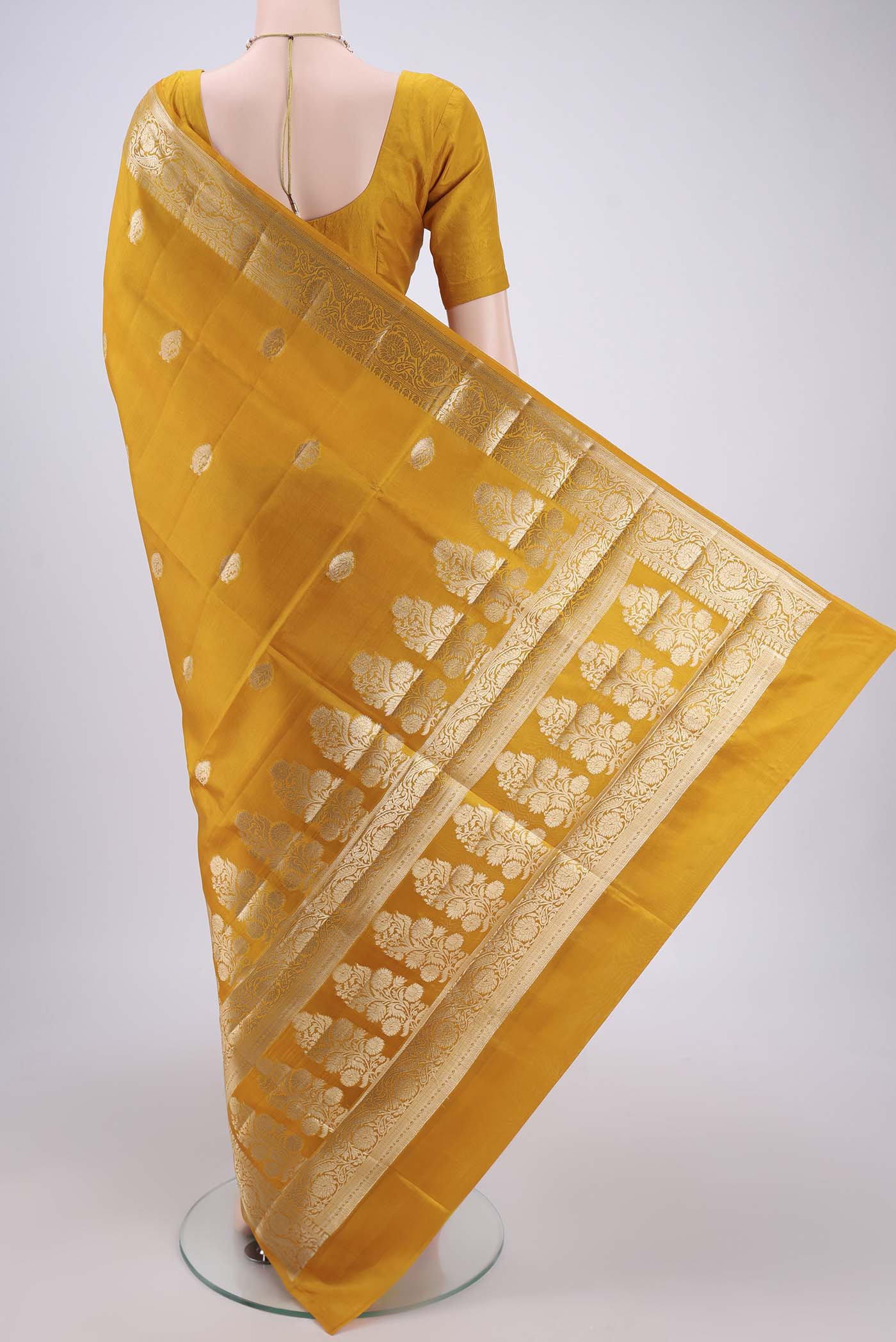 Flat view of Yellow Banarasi Raw Silk Saree with Zari Butta on the body and Zari Border. 