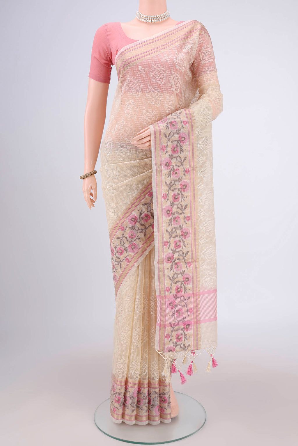 Cream Blended Kota Cotton Saree with Embroidery on the body and Thread Border.  displayed on a mannequin