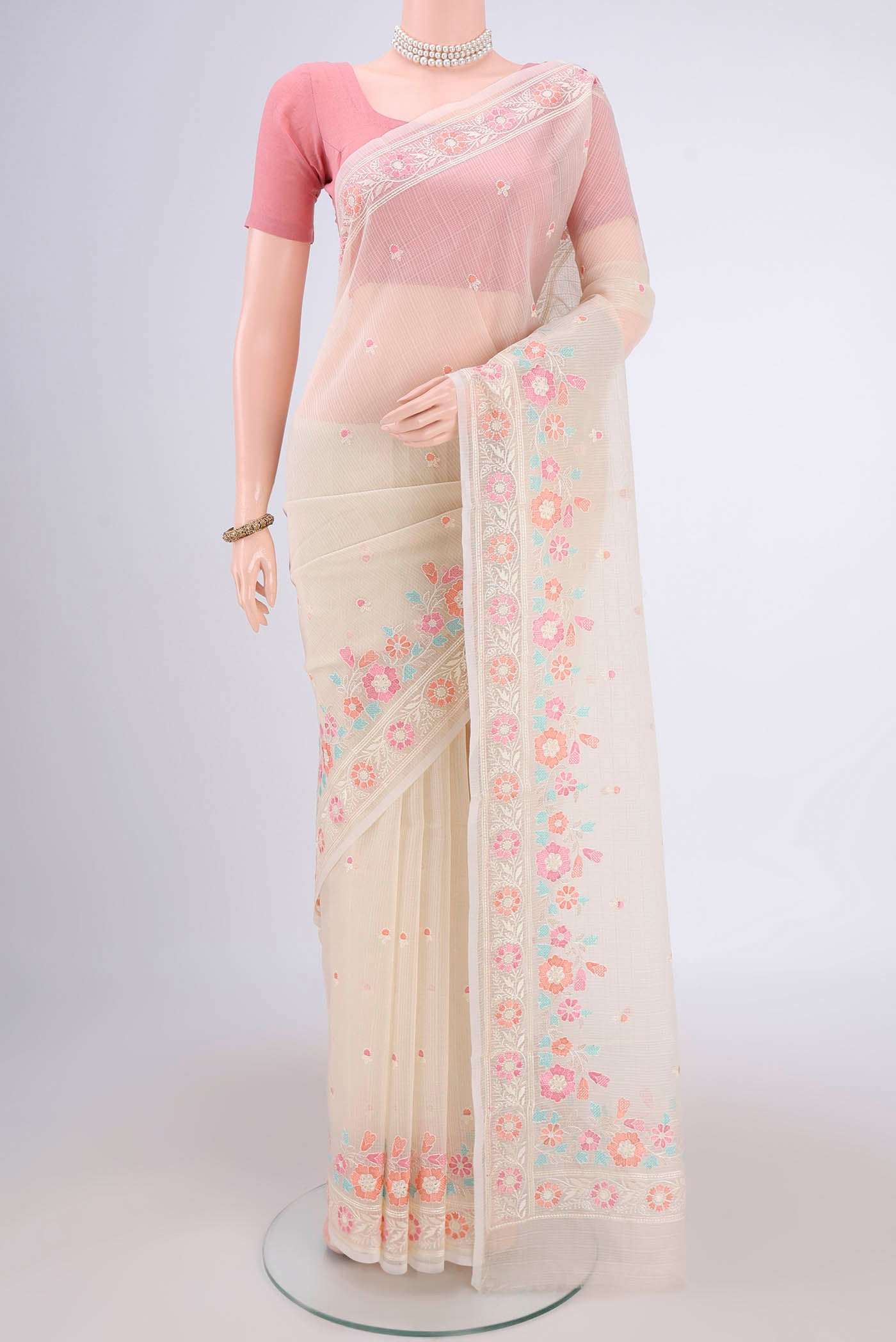 Off White Blended Kota Cotton Saree with Thread Butta on the body and Embroidery Border.  displayed on a mannequin