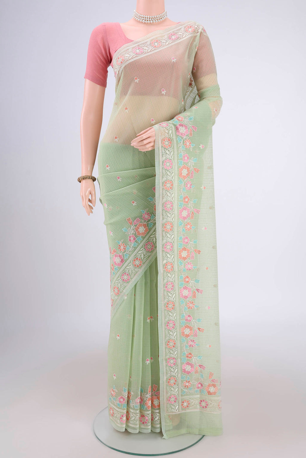 Light Green Blended Kota Cotton Saree with Thread Butta on the body and Embroidery Border.  displayed on a mannequin