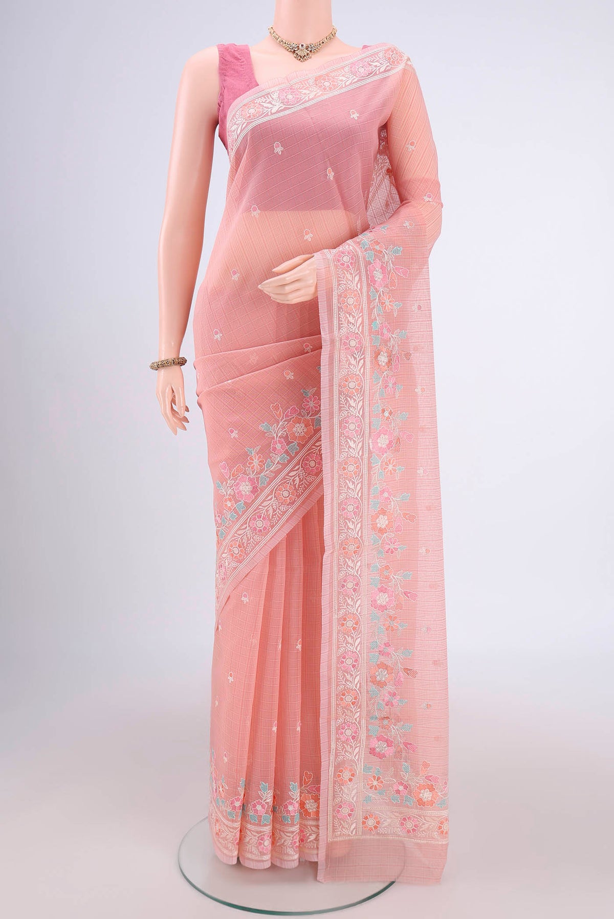 Peach Blended Kota Cotton Saree with Embroidery on the body and Embroidery Border.  displayed on a mannequin