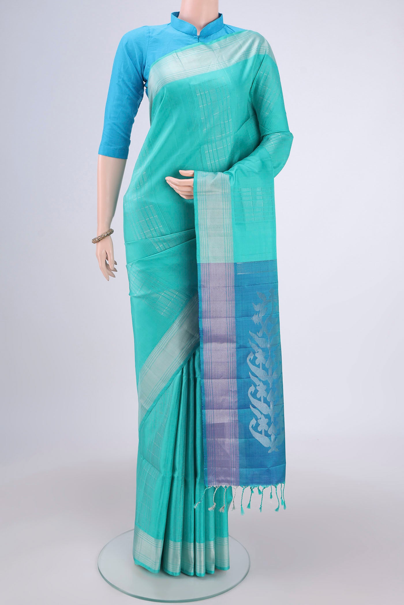 Turquoise Soft Silk Saree with Stripes on the body and Zari Border.  displayed on a mannequin