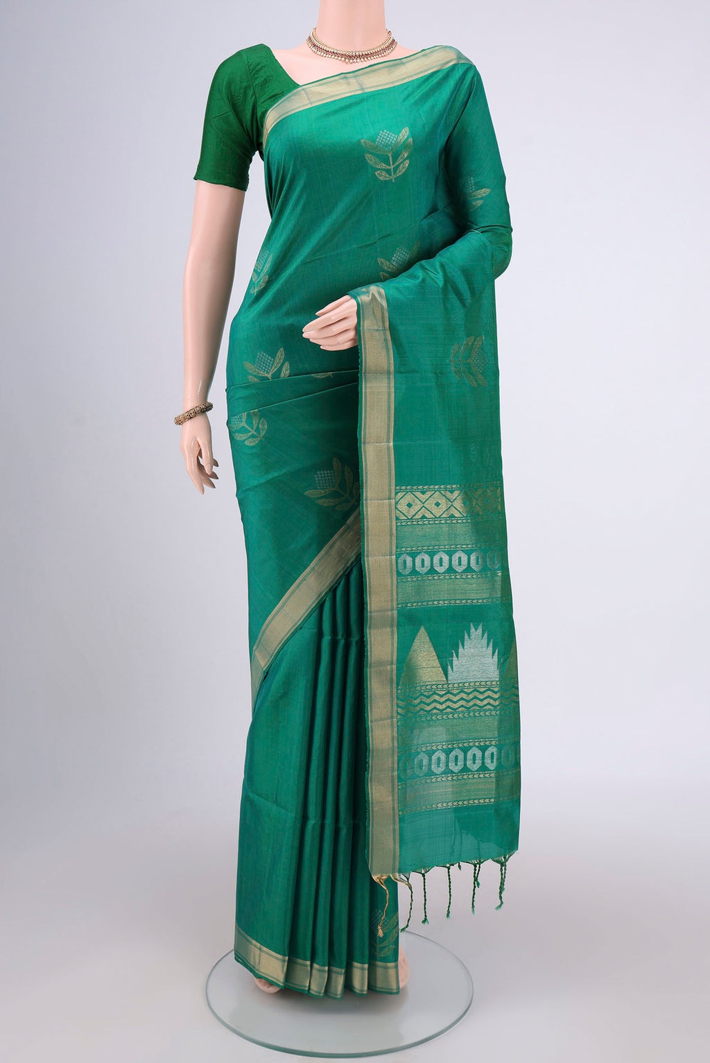 Green Dual Tone Baluchari Silk Saree with Zari Butta on the body and Zari Border.  displayed on a mannequin