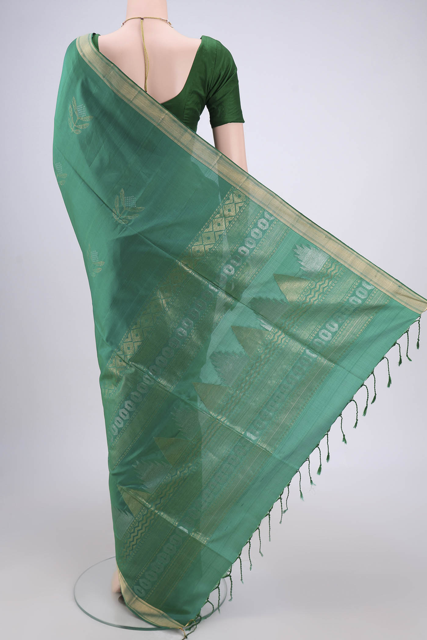 Flat view of Green Dual Tone Baluchari Silk Saree with Zari Butta on the body and Zari Border. 
