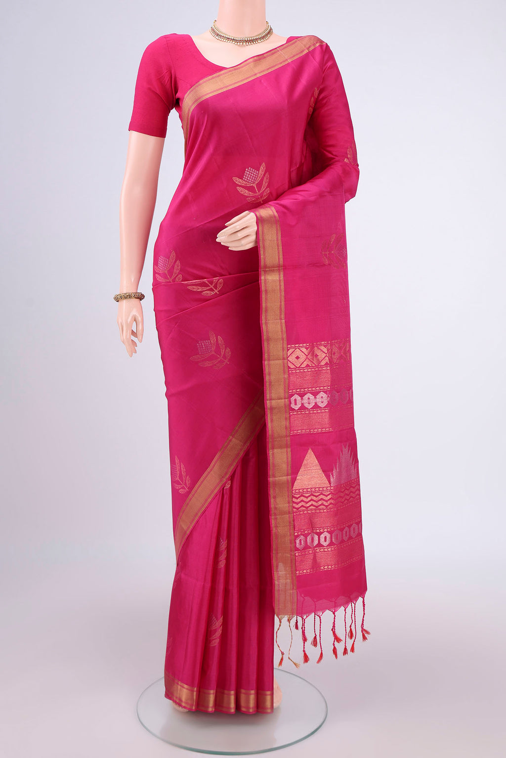Rani Pink Baluchari Silk Saree with Zari Butta on the body and Zari Border.  displayed on a mannequin