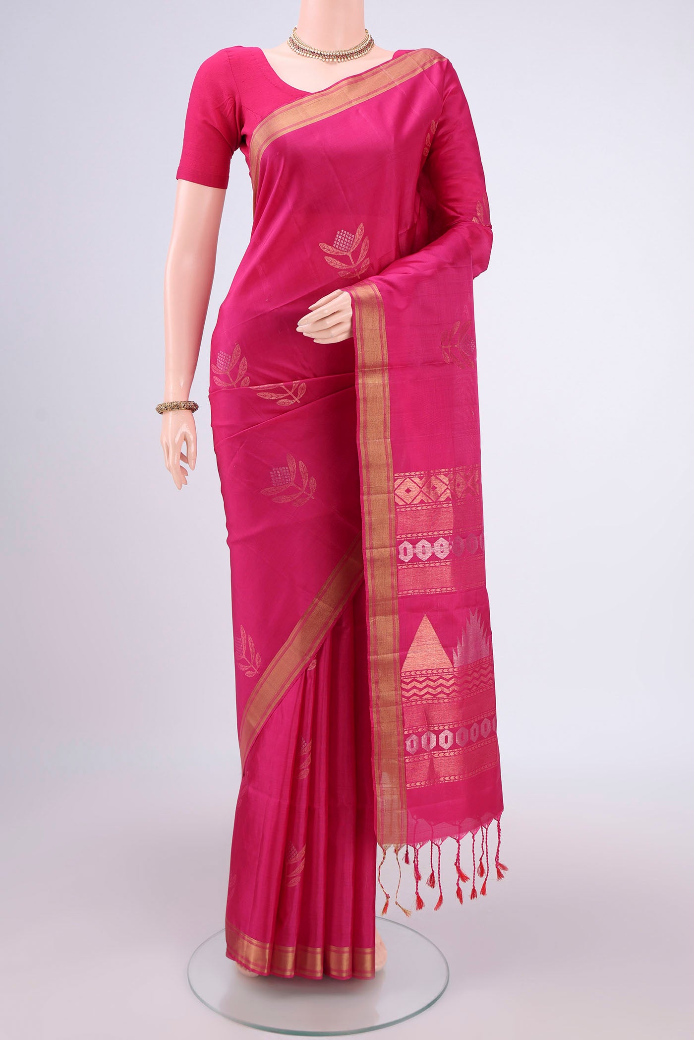 Rani Pink Baluchari Silk Saree with Zari Butta on the body and Zari Border.  displayed on a mannequin