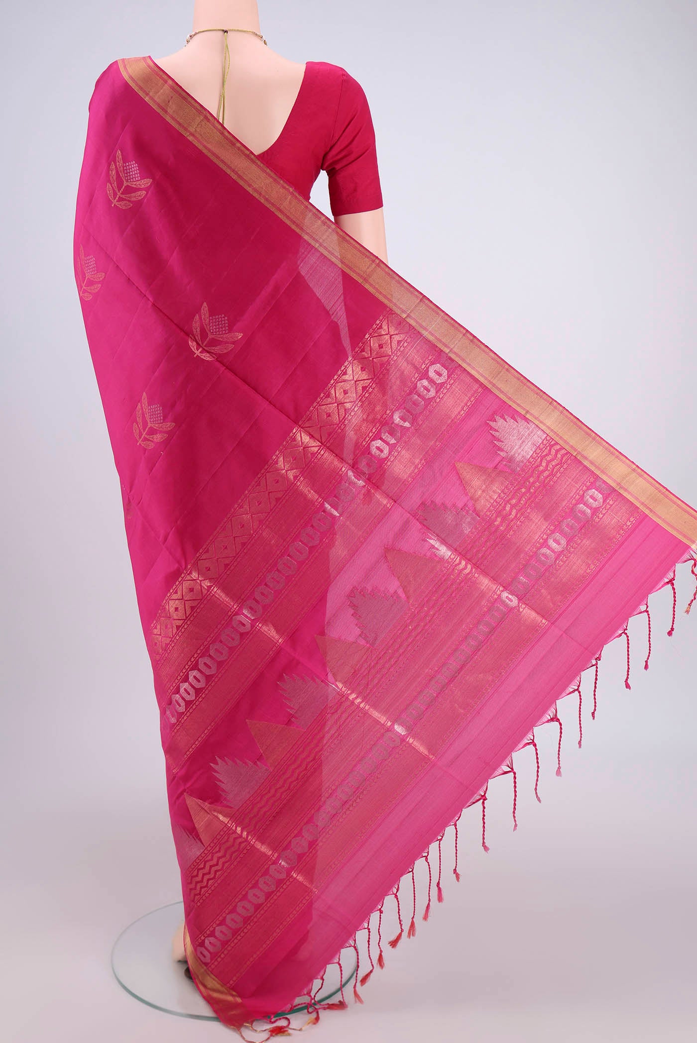 Flat view of Rani Pink Baluchari Silk Saree with Zari Butta on the body and Zari Border. 