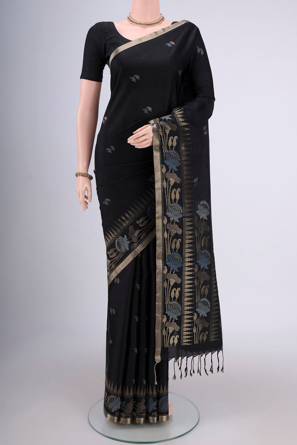 Black Baluchari Silk Saree with Zari And Thread Butta on the body and Zari Border.  displayed on a mannequin