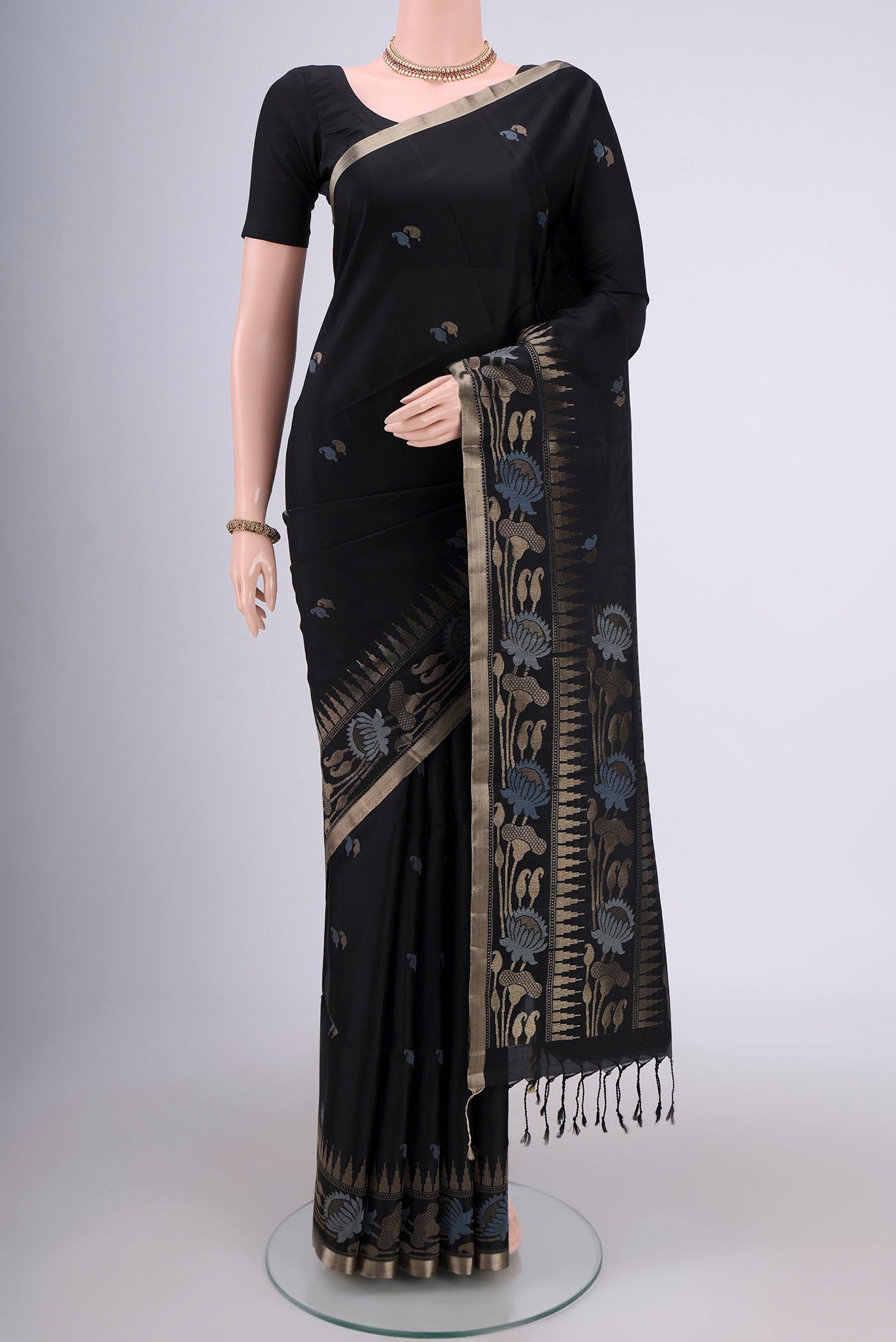 Black Baluchari Silk Saree with Zari And Thread Butta on the body and Zari Border.  displayed on a mannequin