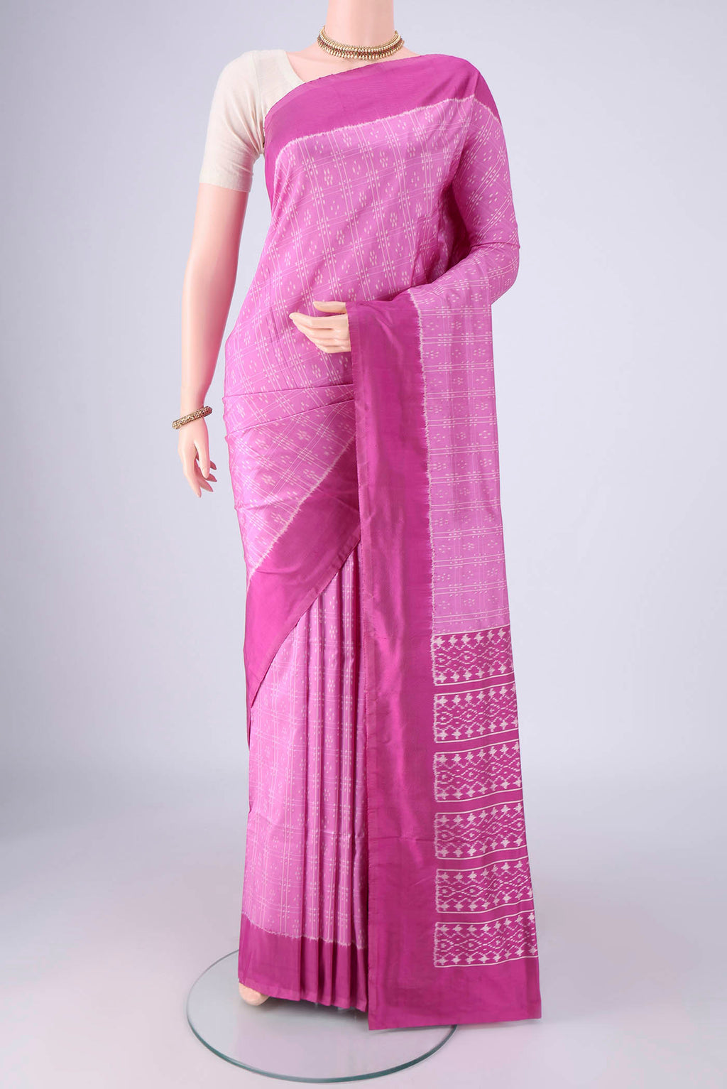 Rose pink Pochampally Silk Saree with Checked design on the body and Plain Border.  displayed on a mannequin