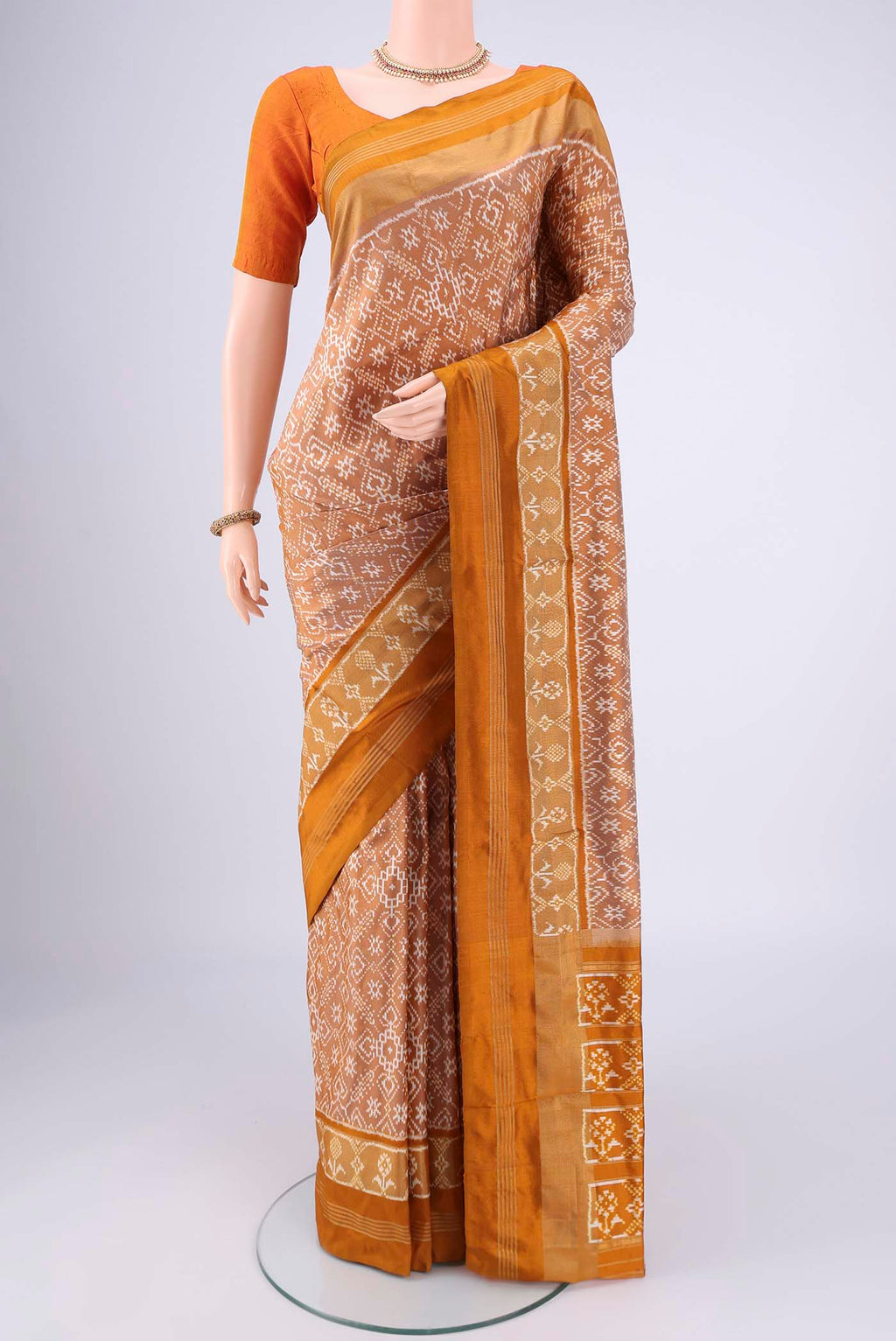 Sandal Pochampally Silk Saree with Checked design on the body and Zari Border.  displayed on a mannequin