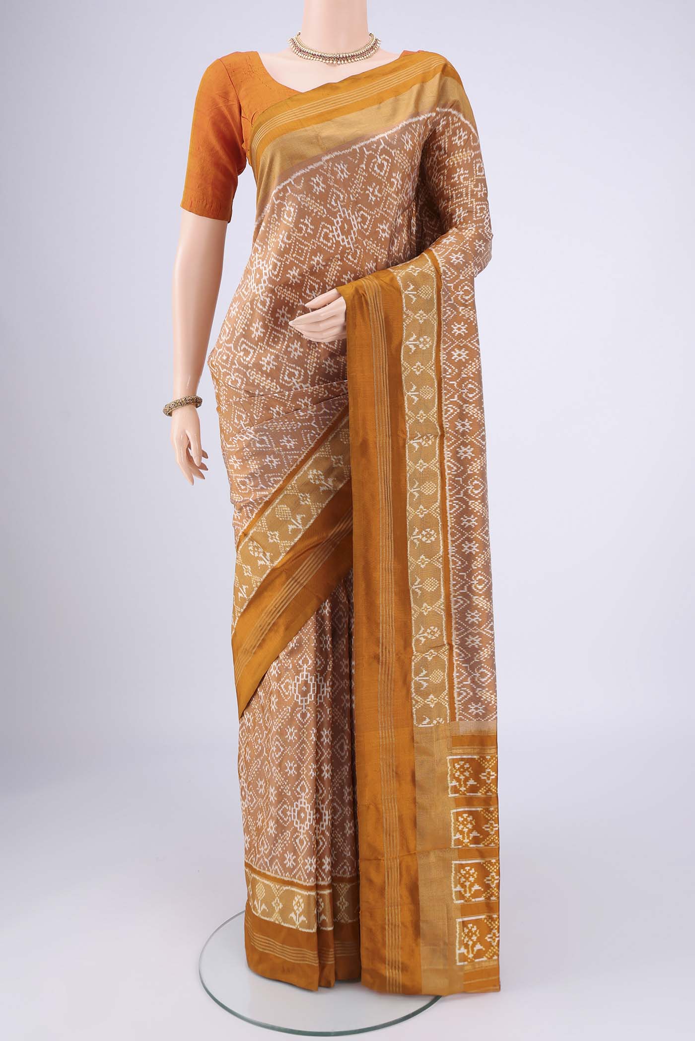 Sandal Pochampally Silk Saree with Checked design on the body and Zari Border.  displayed on a mannequin