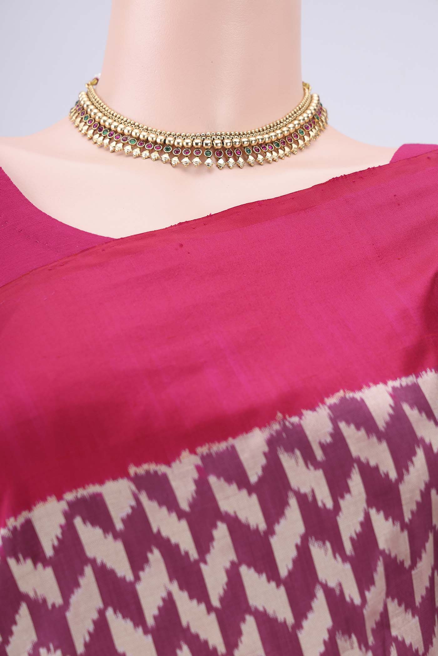 Border image of Magenta Pochampally Silk Saree with Ikat design on the body and Zari Border. 