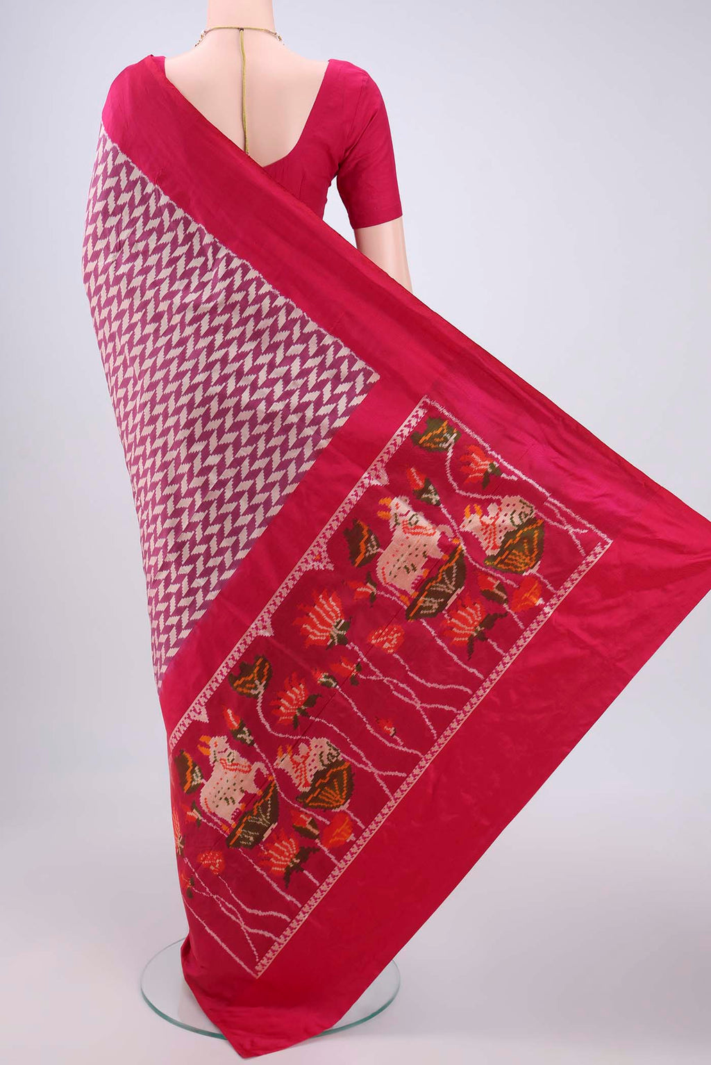 Flat view of Magenta Pochampally Silk Saree with Ikat design on the body and Zari Border. 