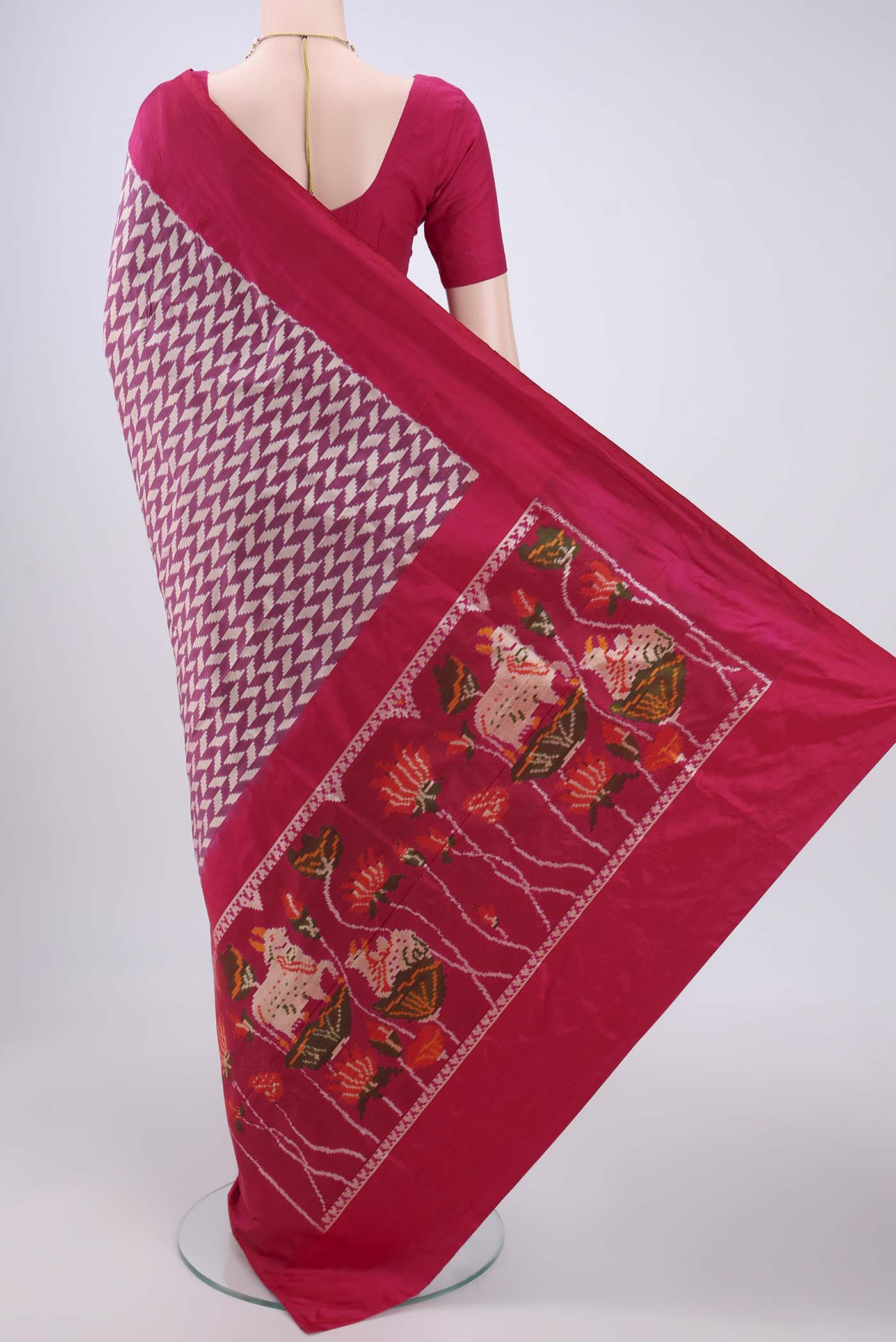 Flat view of Magenta Pochampally Silk Saree with Ikat design on the body and Zari Border. 