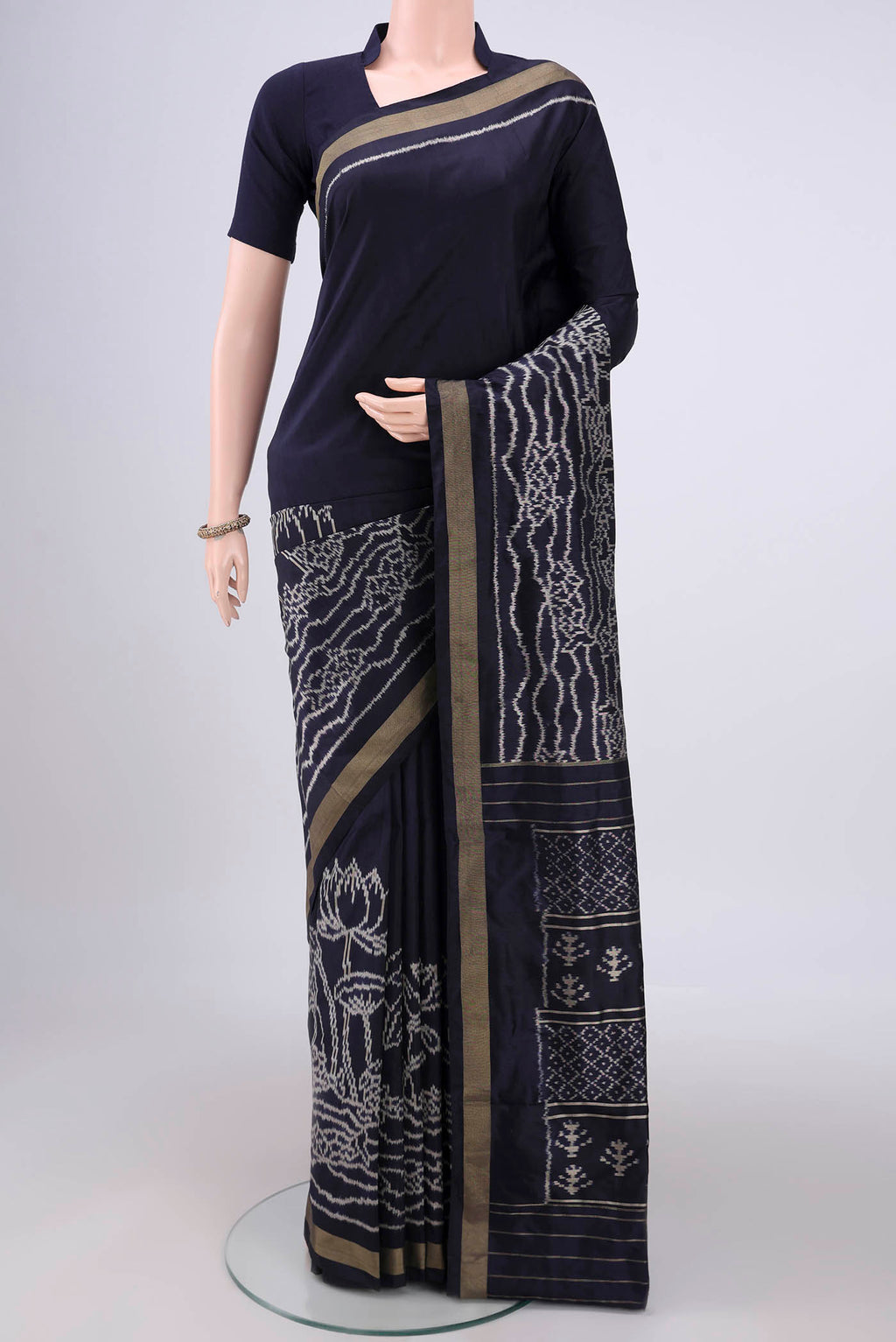 Navy Blue Pochampally Silk Saree with Ikat design on the body and Zari Border.  displayed on a mannequin