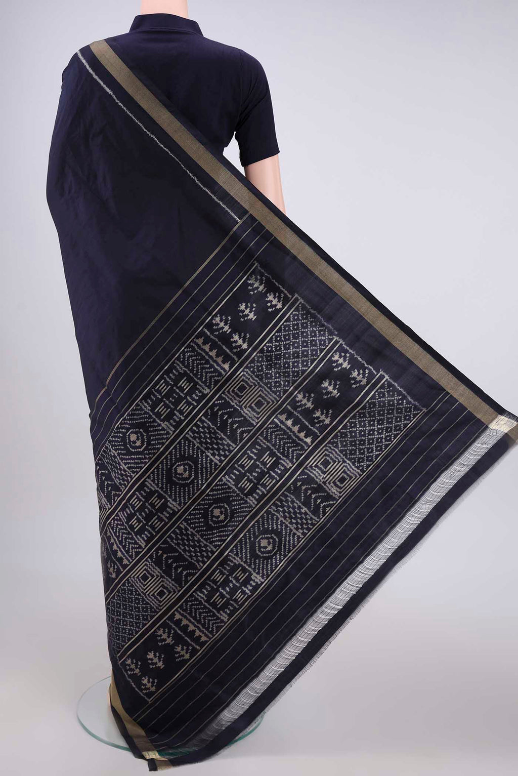 Flat view of Navy Blue Pochampally Silk Saree with Ikat design on the body and Zari Border. 
