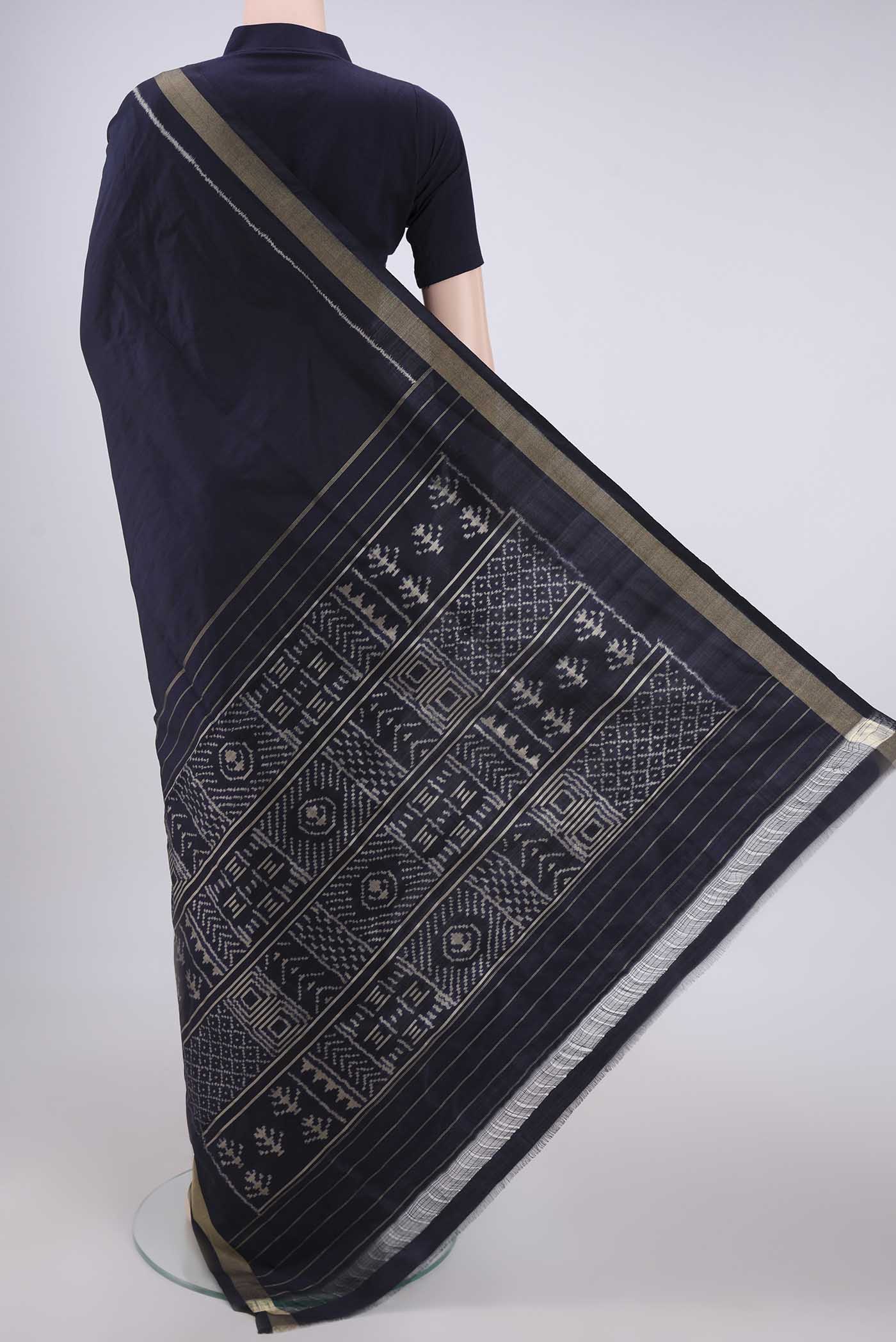 Flat view of Navy Blue Pochampally Silk Saree with Ikat design on the body and Zari Border. 