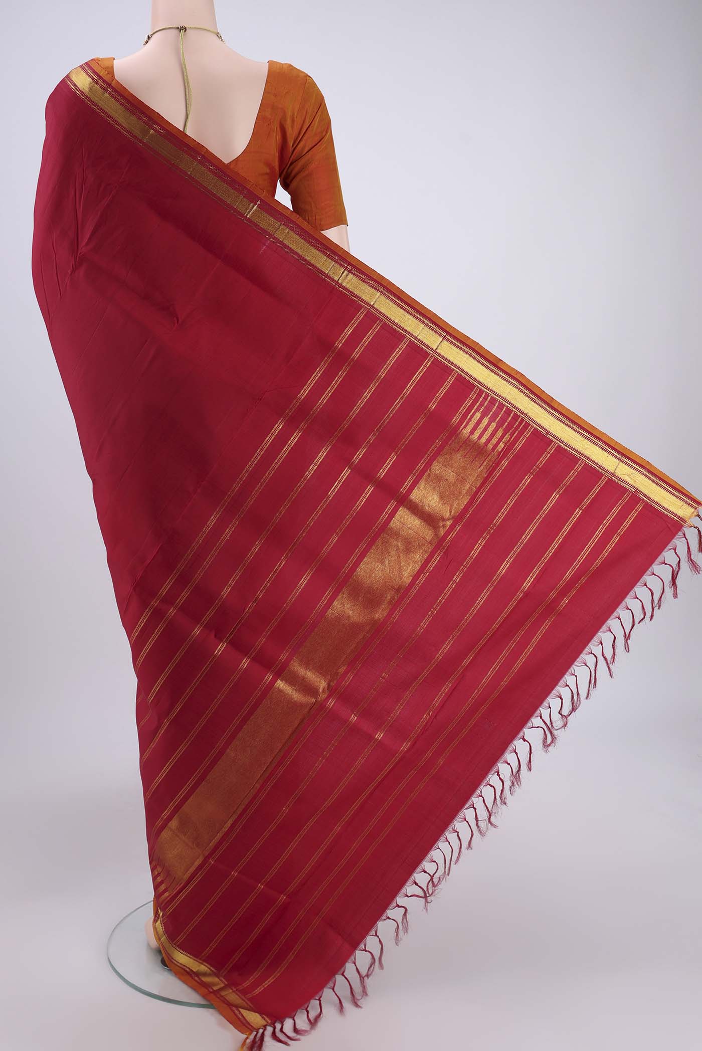 Flat view of Red Kanjivaram Silk Saree with Zari Butta on the body and Zari Border. 
