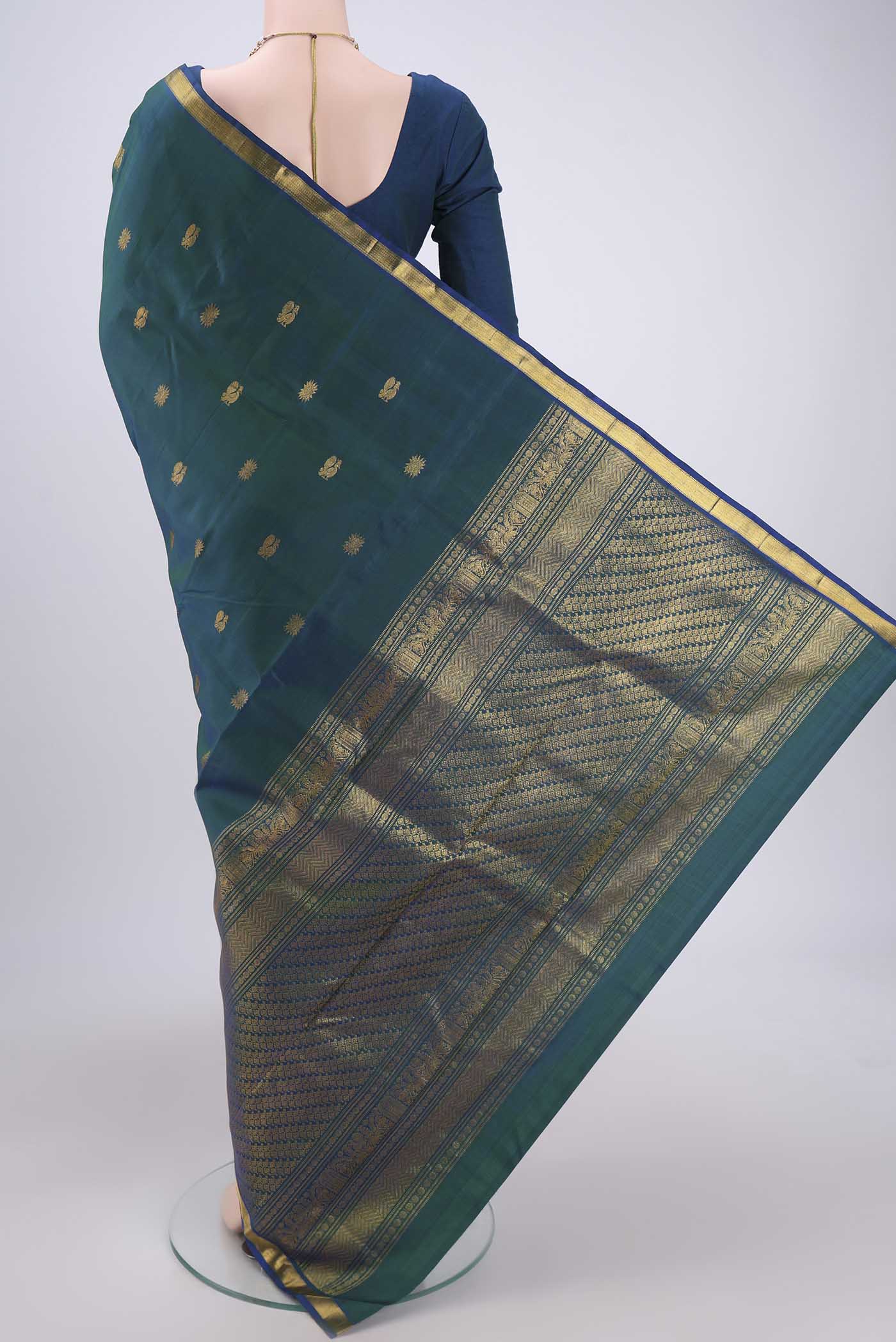 Flat view of Turquoise Kanjivaram Silk Saree with Zari Butta on the body and Zari Border. 