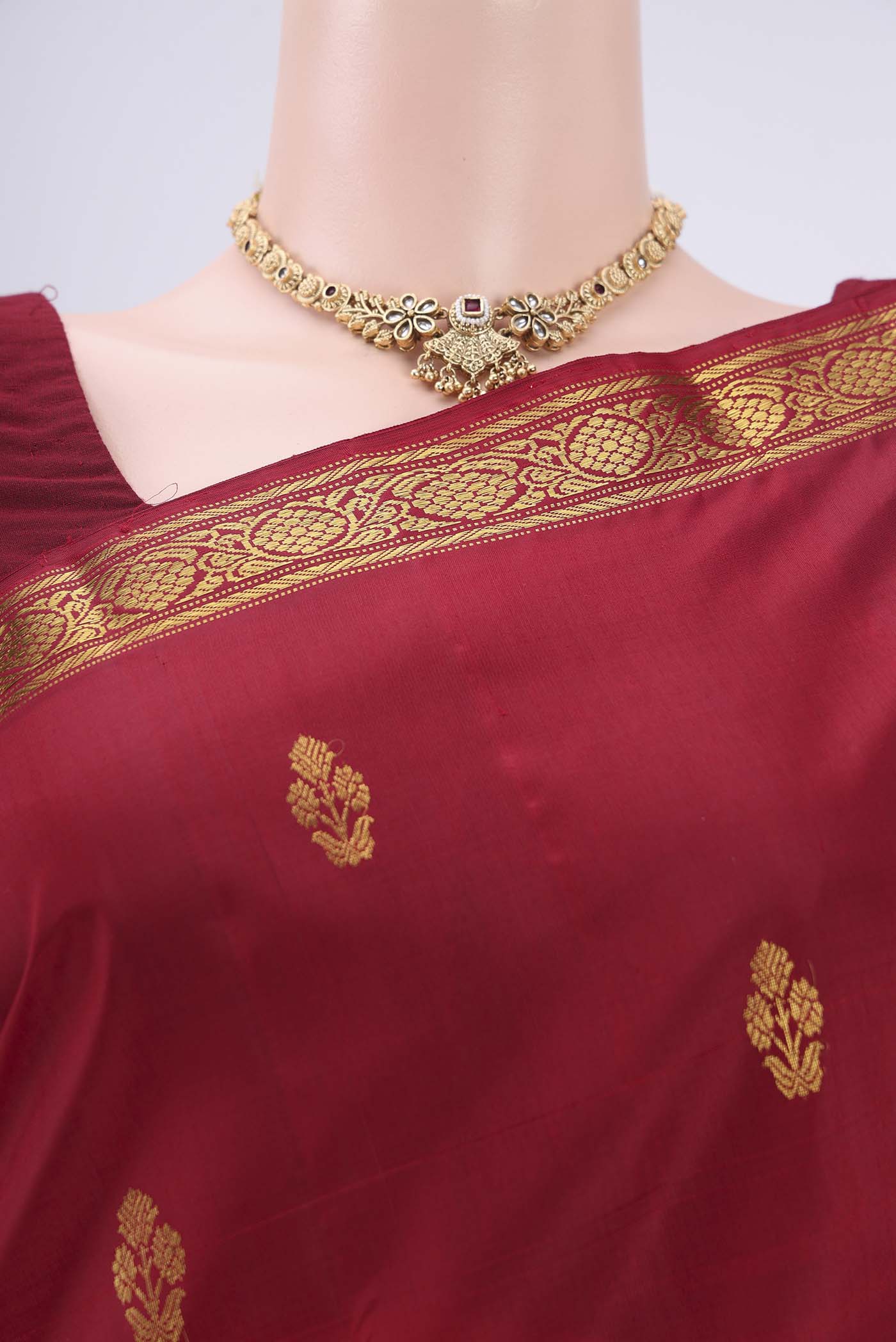 Border image of Maroon Kanjivaram Silk Saree with Zari Butta on the body and Zari Border. 