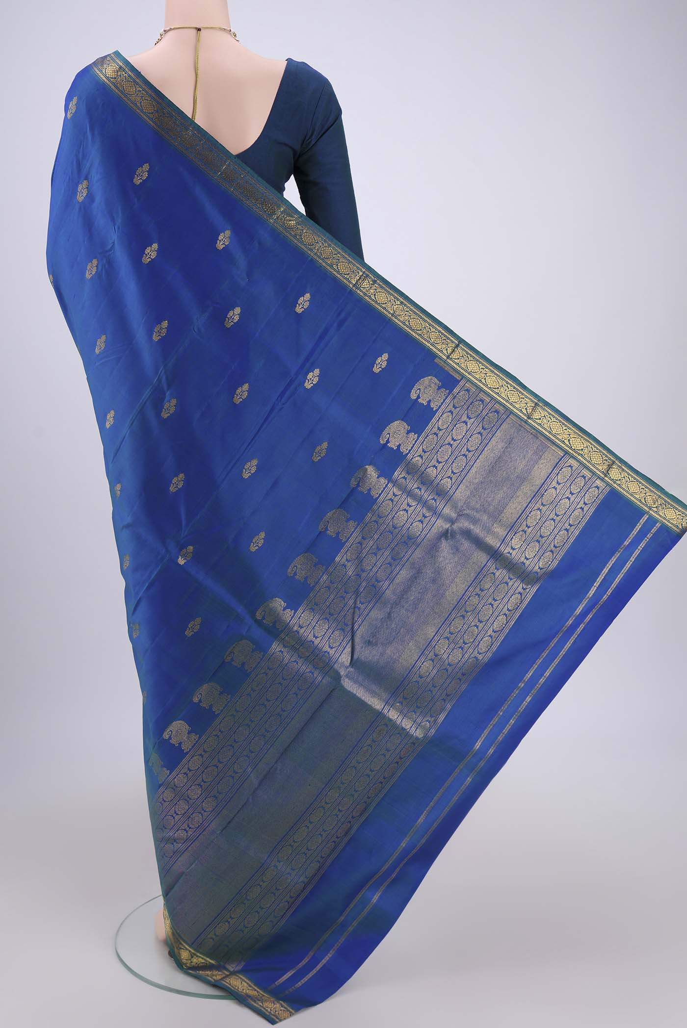 Flat view of Turquoise Kanjivaram Silk Saree with Zari Butta on the body and Zari Border. 
