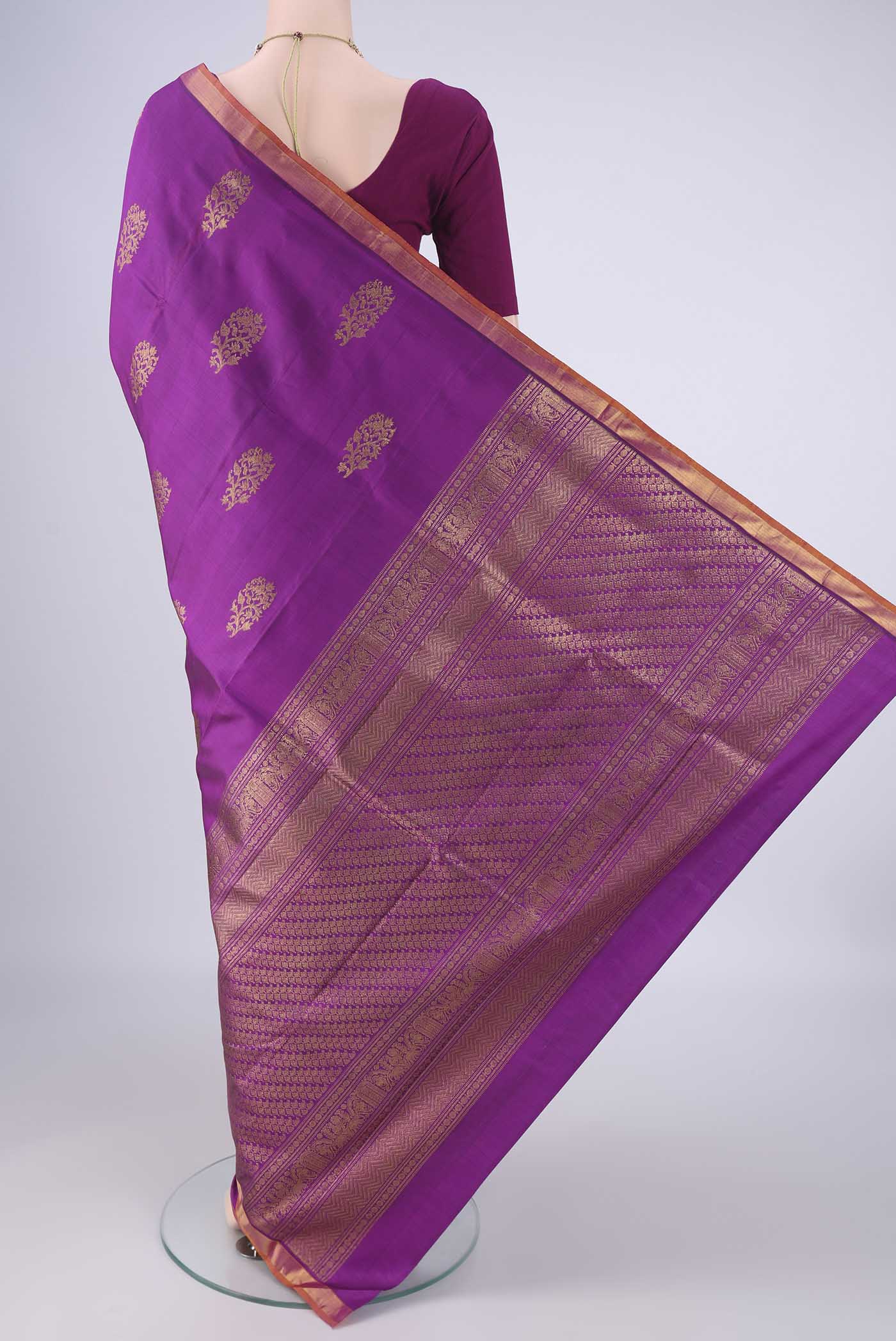 Flat view of Purple Kanjivaram Silk Saree with Zari Butta on the body and Zari Border. 