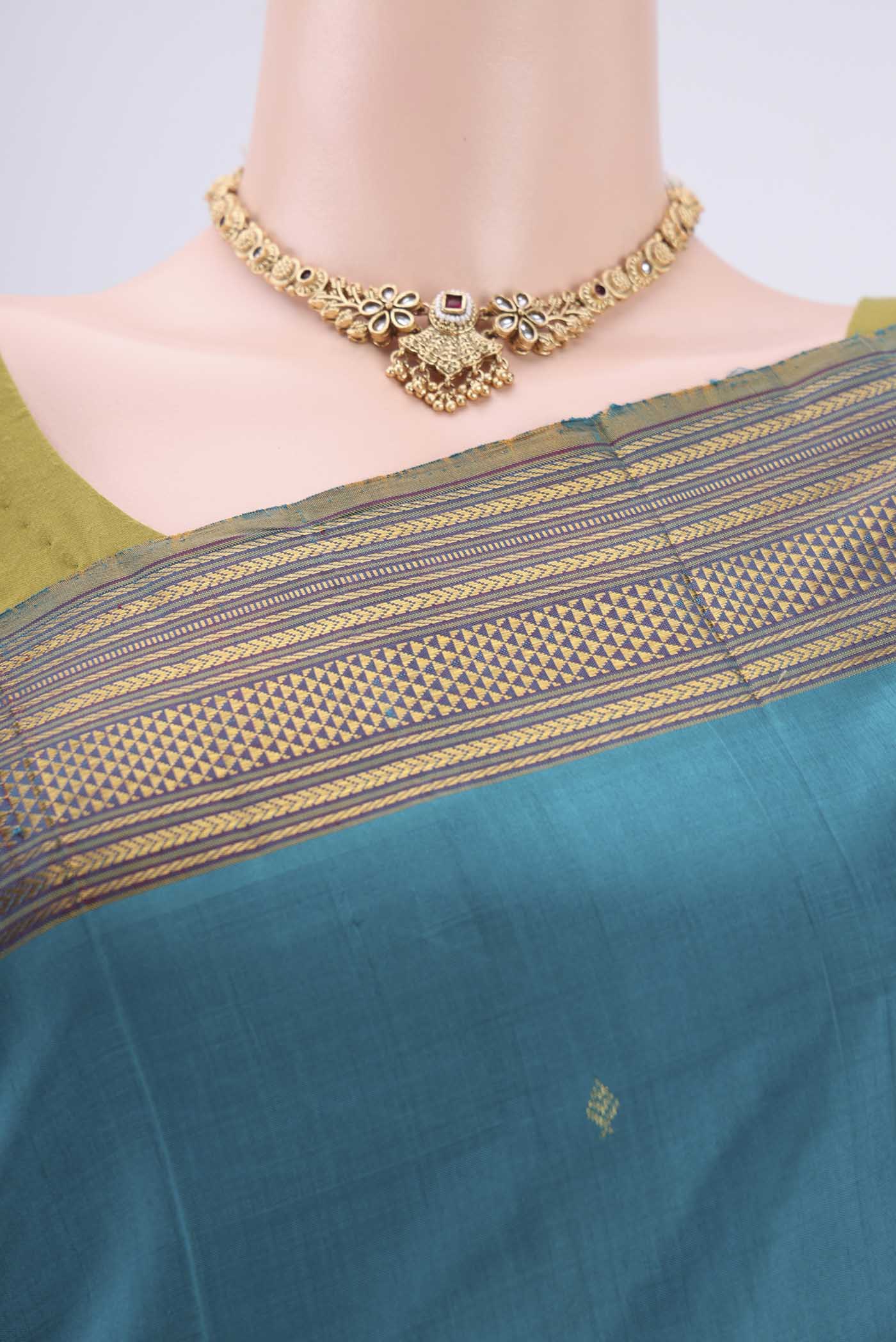 Border image of Turquoise Kanchipuram Silk Saree with Zari Butta on the body and Zari Border. 