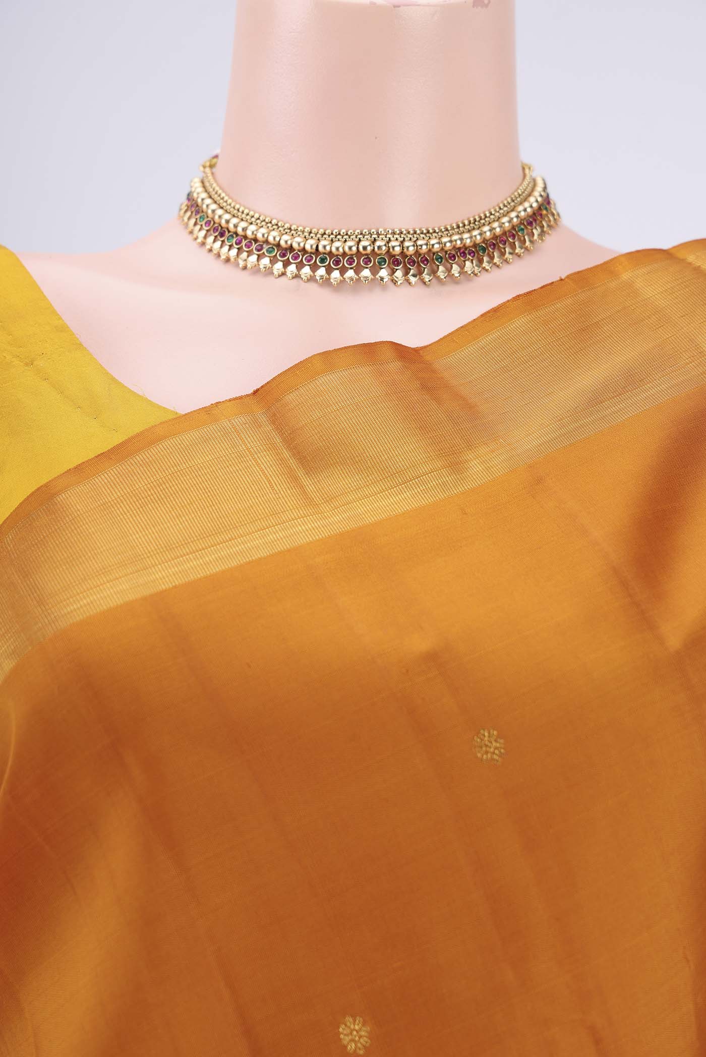 Border image of Mustard Kanjivaram Silk Saree with Zari Butta on the body and Zari Border. 