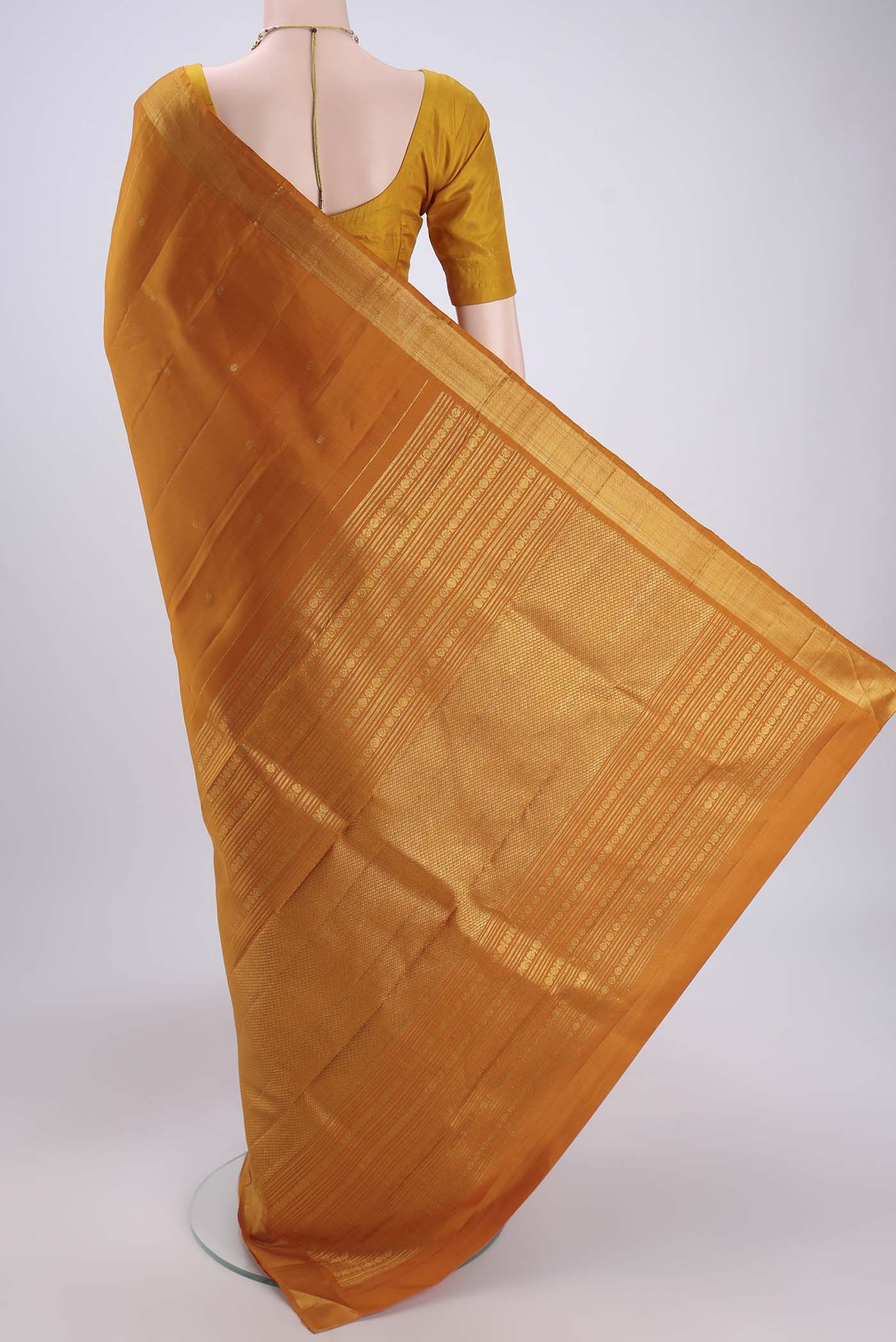 Flat view of Mustard Kanjivaram Silk Saree with Zari Butta on the body and Zari Border. 