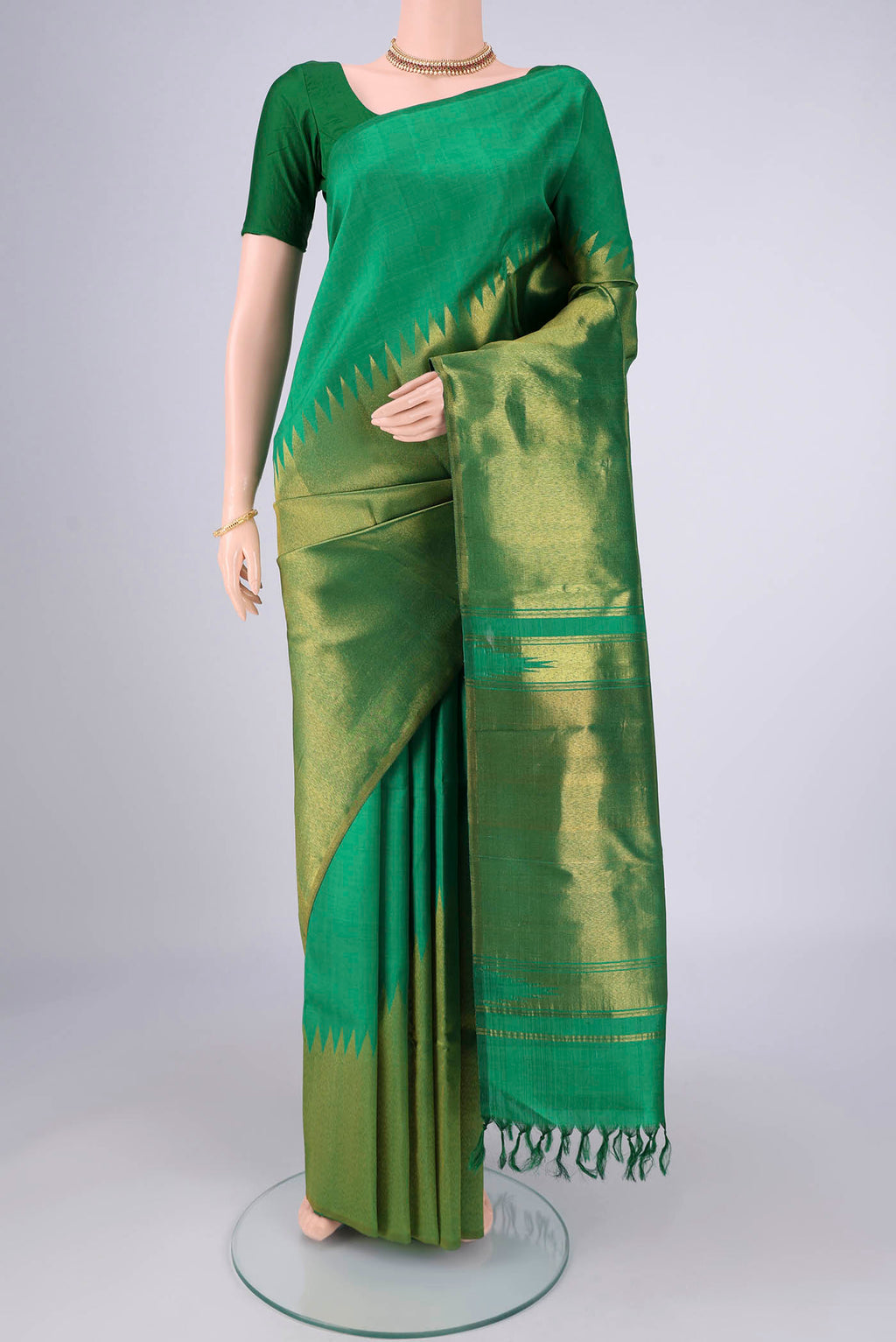 Pure Silk Pure Zari Green Kanjivaram Saree with Plain Body and Rising Temple Border.  displayed on a mannequin