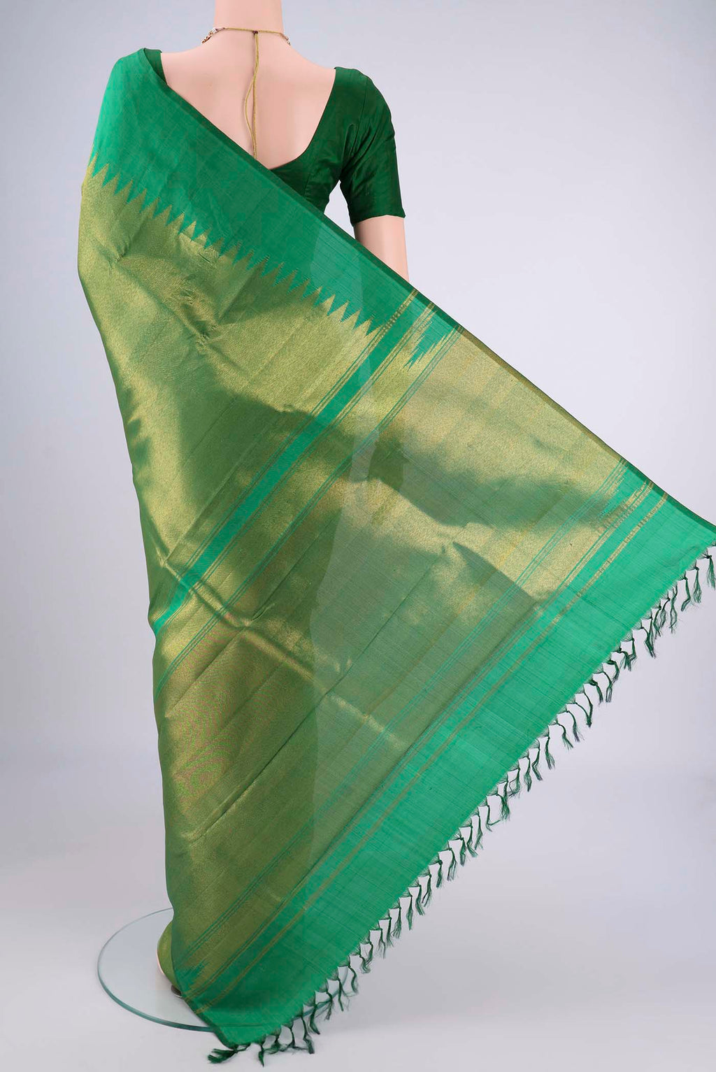 Flat view of Pure Silk Pure Zari Green Kanjivaram Saree with Plain Body and Rising Temple Border. 