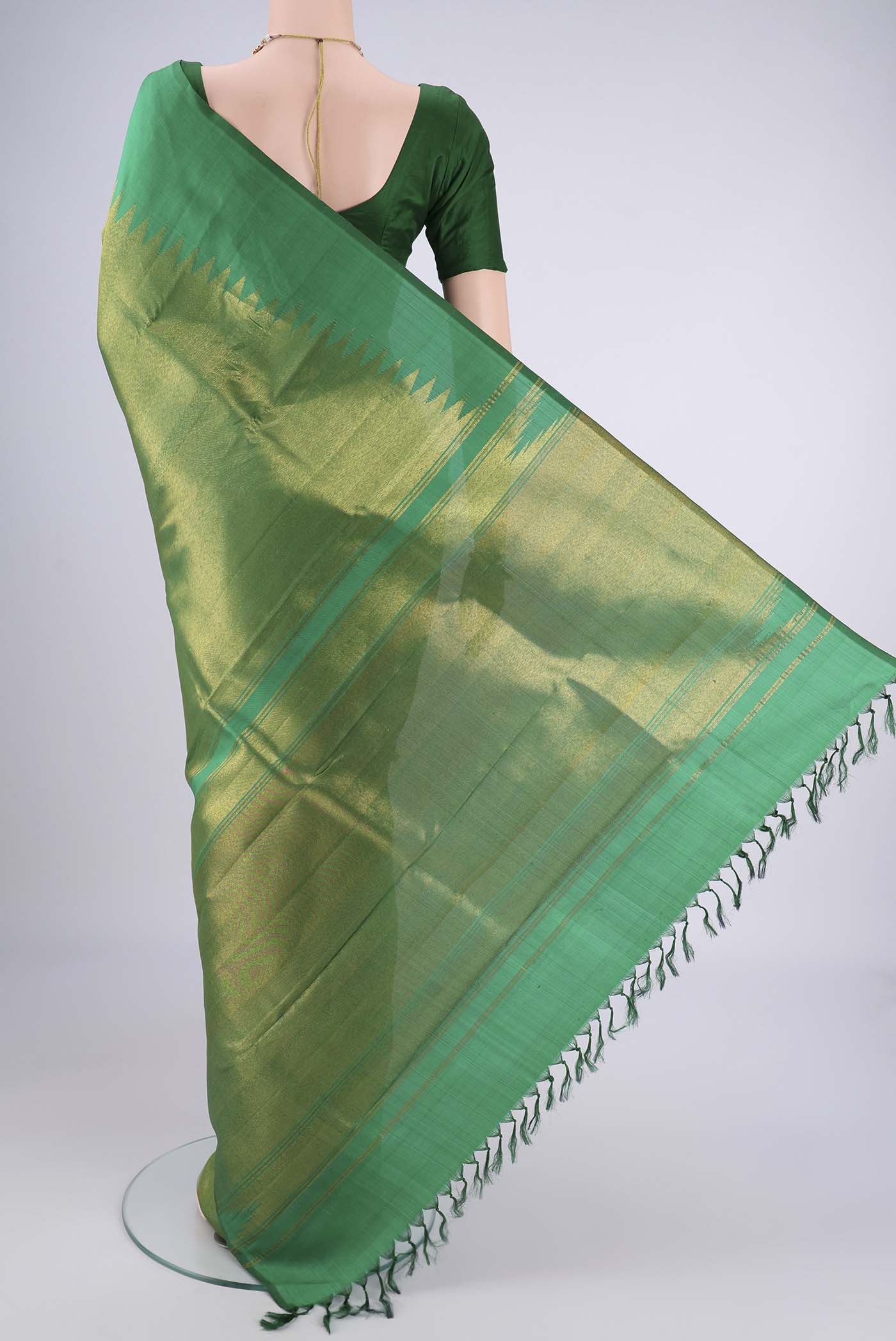 Flat view of Pure Silk Pure Zari Green Kanjivaram Saree with Plain Body and Rising Temple Border. 