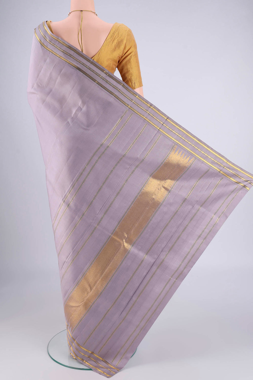 Flat view of Lilac Kanchipuram Silk Saree with Plain Body and Zari Border. 