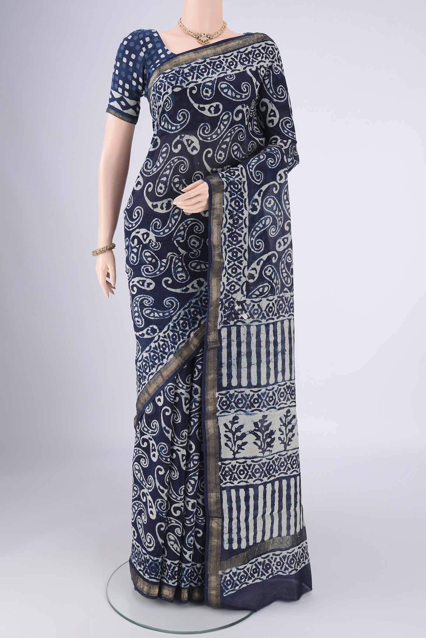 Indigo Maheshwari Silk Cotton Saree with Batik Print on the body and Zari Border.  displayed on a mannequin