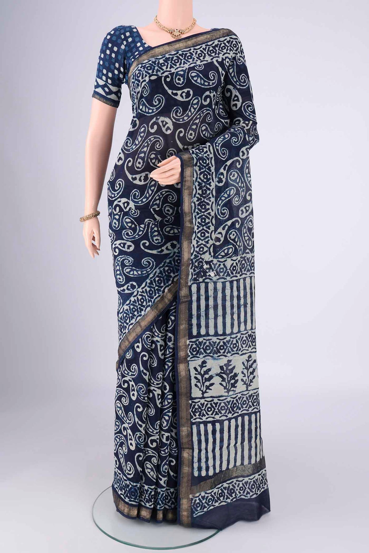 Indigo Maheshwari Silk Cotton Saree with Batik Print on the body and Zari Border.  displayed on a mannequin