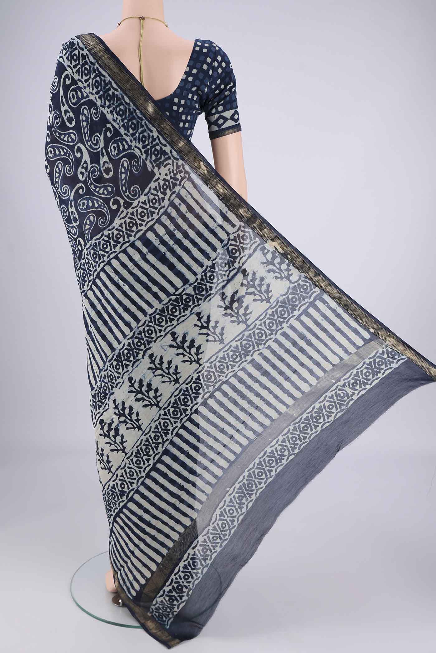 Flat view of Indigo Maheshwari Silk Cotton Saree with Batik Print on the body and Zari Border. 