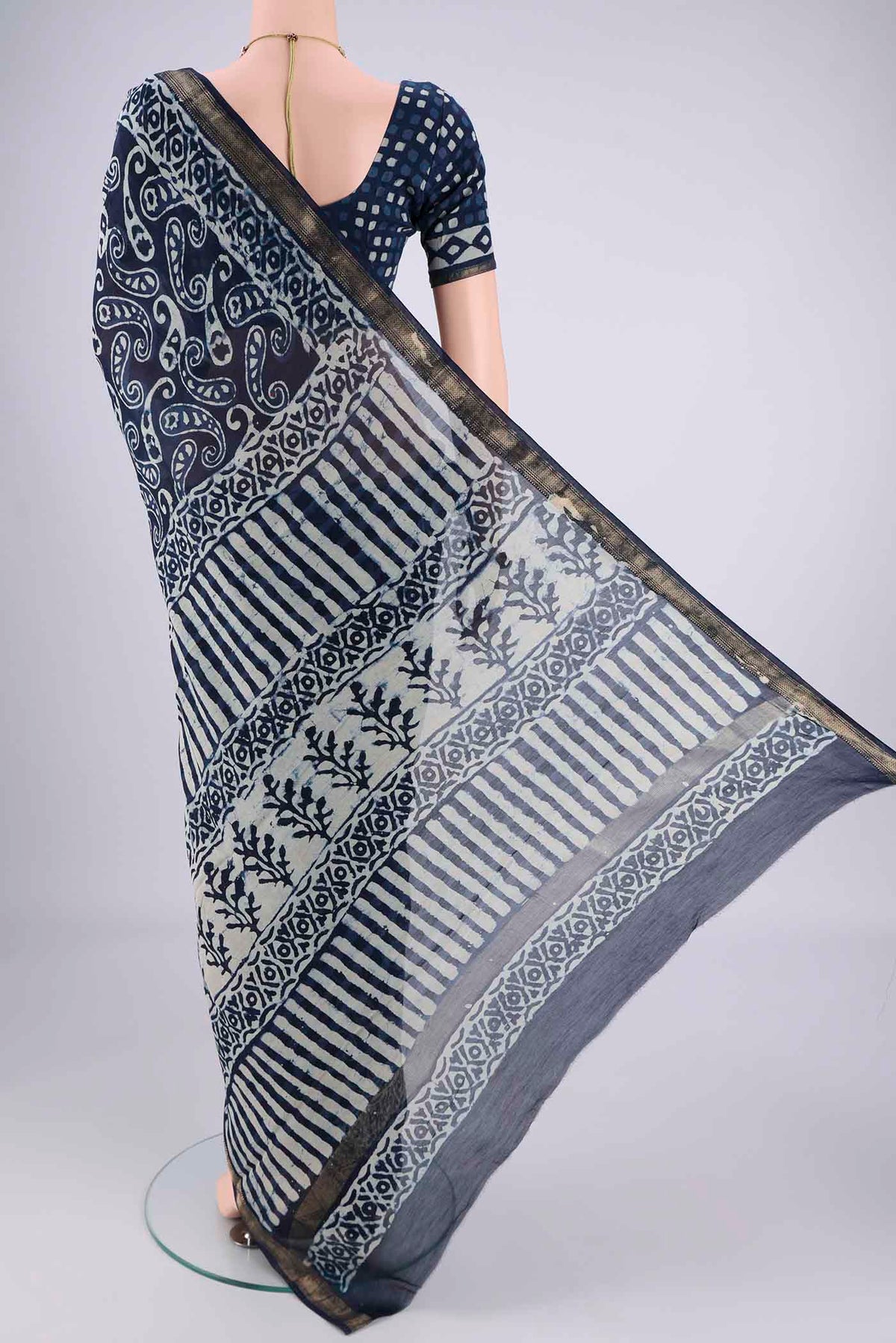 Flat view of Indigo Maheshwari Silk Cotton Saree with Batik Print on the body and Zari Border. 